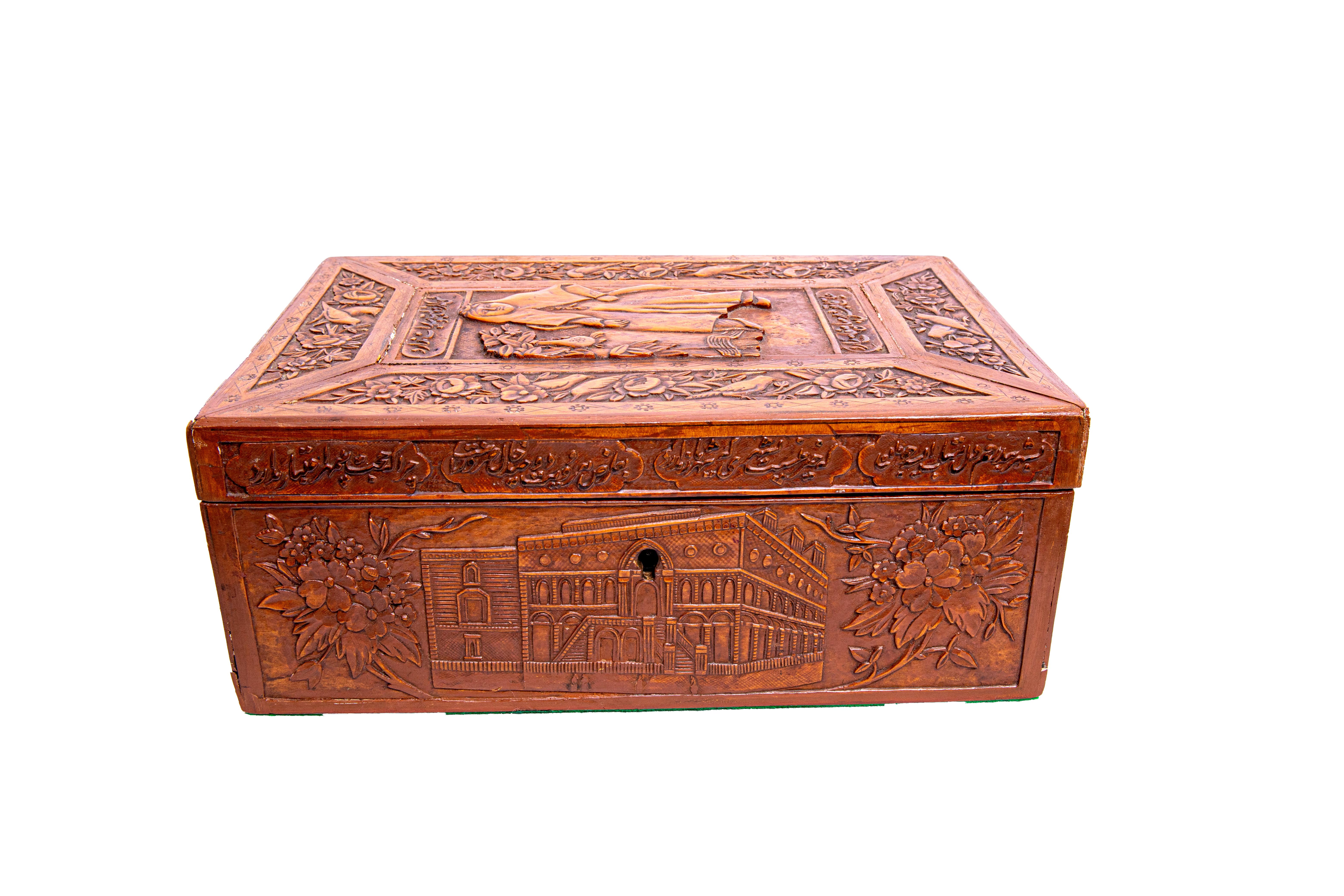 Of rectangular form, the flat top with raised central panel depicts a seated Qajari women wearing a traditional clothes surrounded by flowers and birds design boarders and calligraphy, the sides deeply decorated with different scenes and