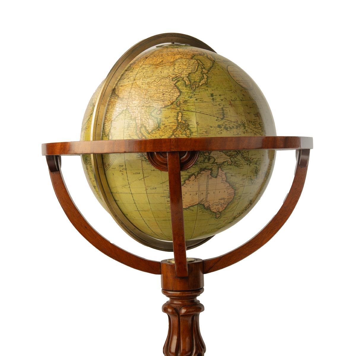 A Cary’s 15 inch terrestrial globe, 1849, set in a mahogany stand with a turned baluster support on three splayed scroll legs centred on a compass rose, the cartouche stating ‘Cary’s New Terrestrial Globe, Drawn from the most recent Geographical