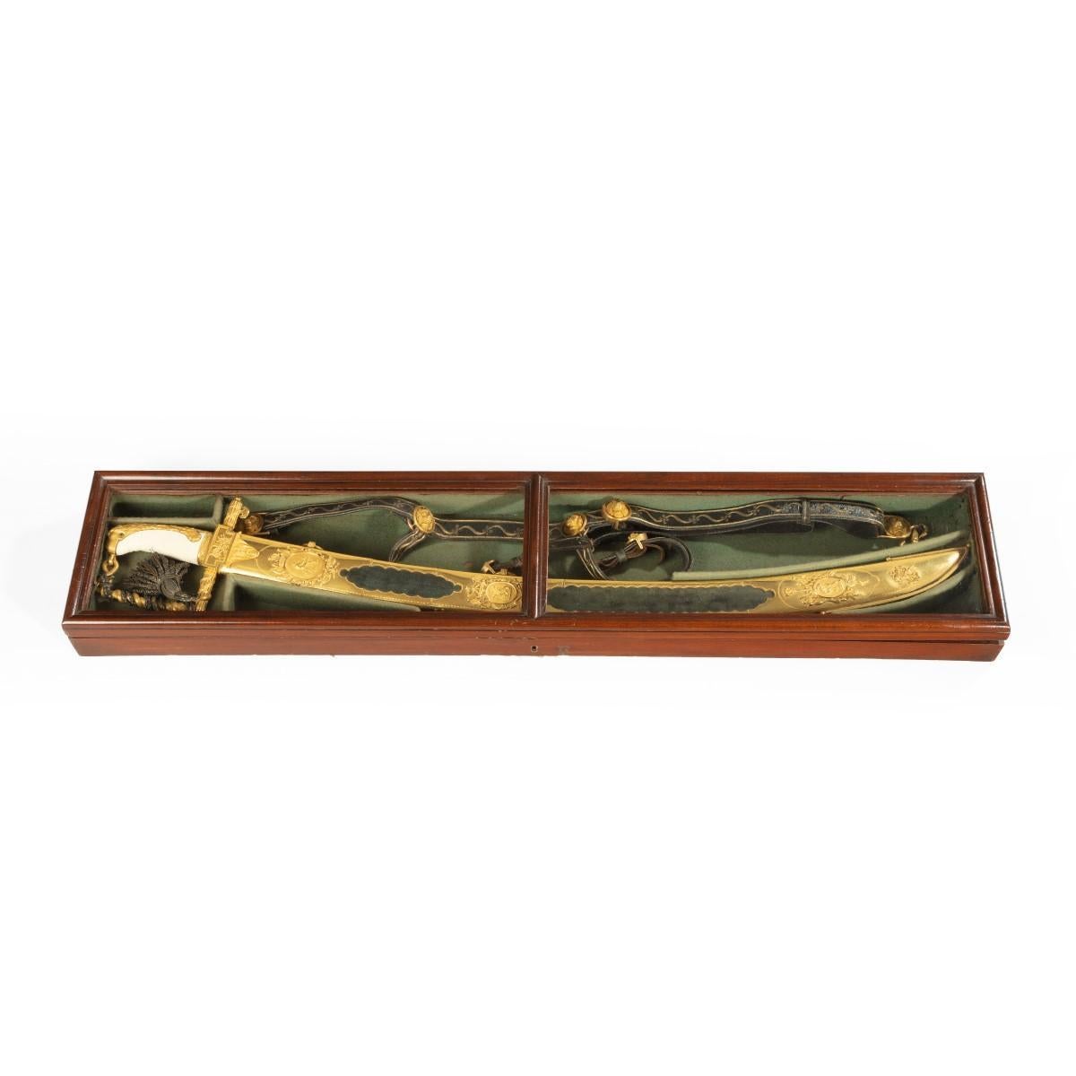 A cased Lloyds £ 50 sword for valour awarded to Lt. Ogle Moore of H.M.S. Maidstone, 1804, the curved single-edged hollow-ground blade (minor areas of wear) richly etched and gilt against blue ground with flowers, foliage, a naval trophy, figures of