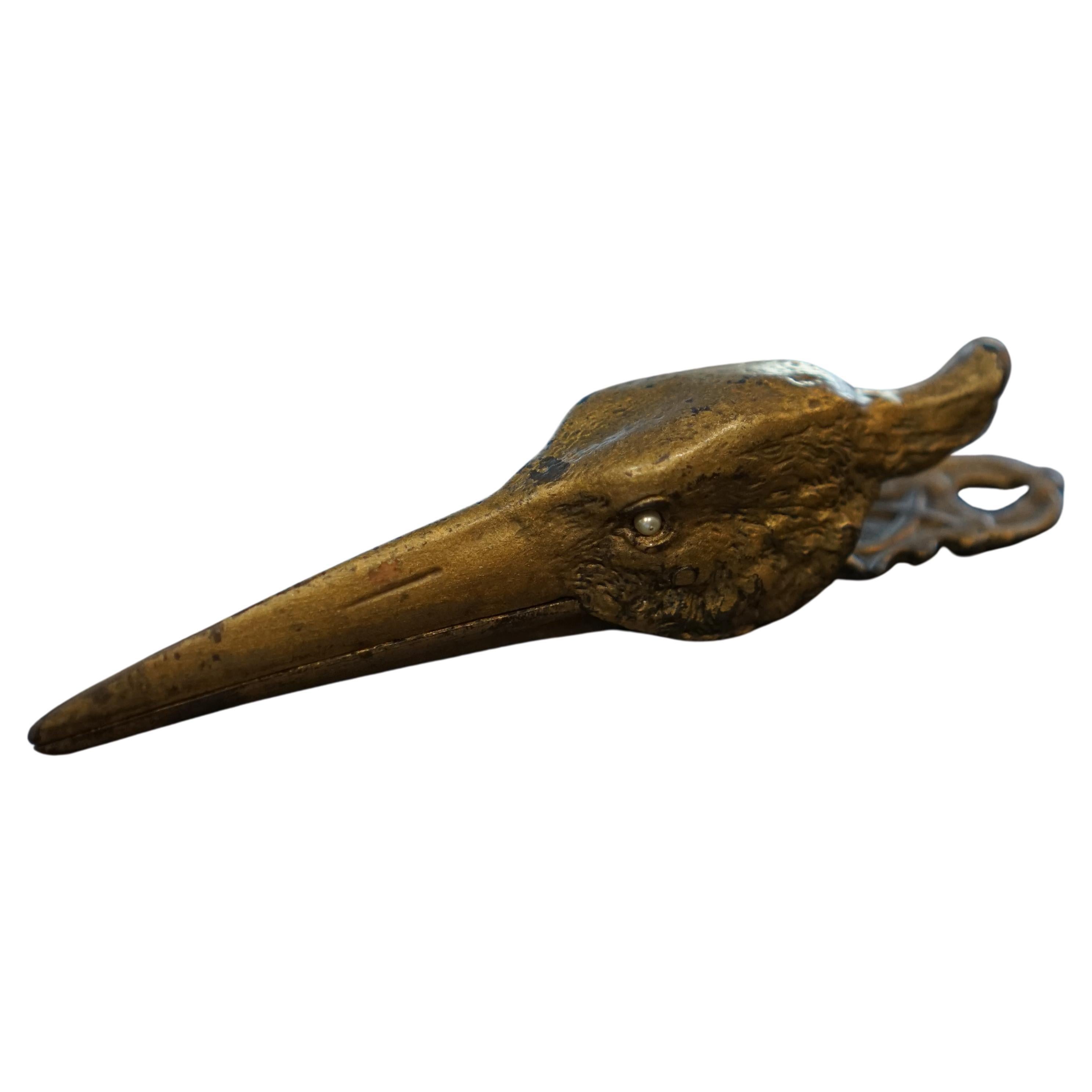 A cast bronze sprung hinged letter / document clip in the form of a crane’s head For Sale