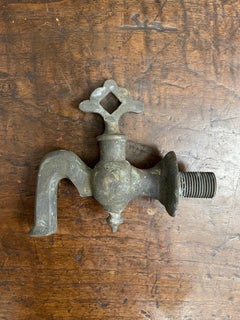 A Cast Bronze Tap with Fixed Handle