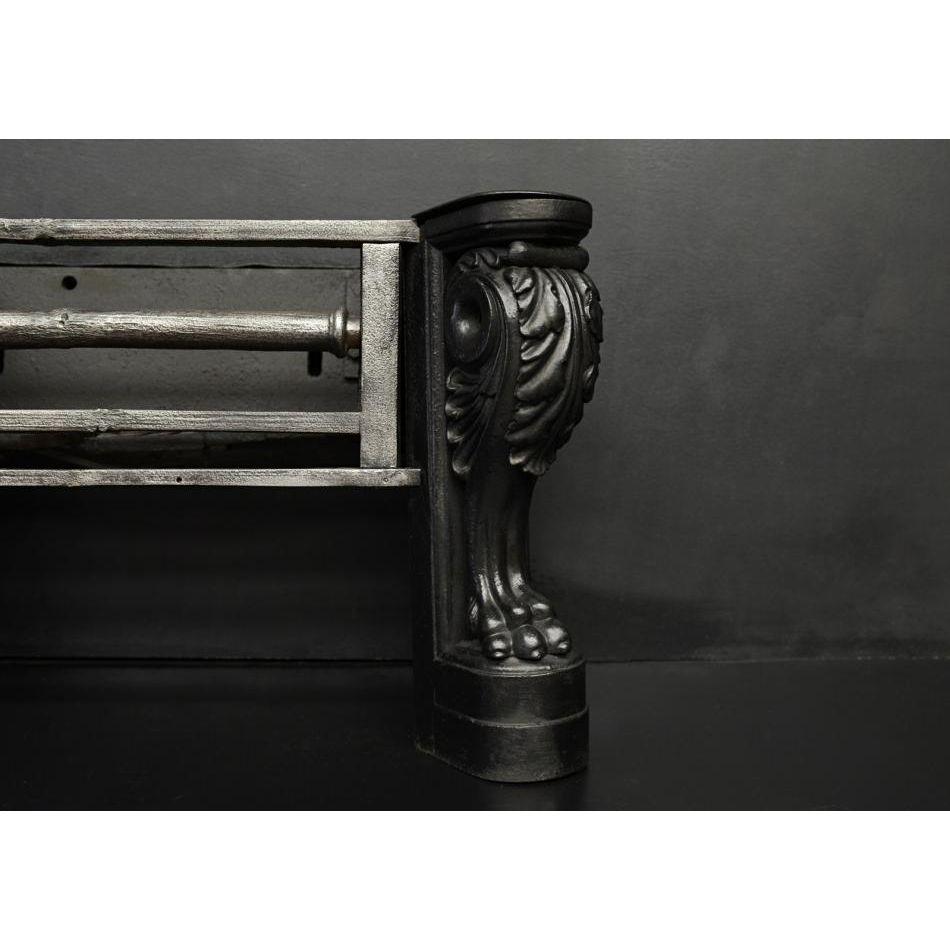 An unusual cast iron firegrate. The double plinthed legs with lion's foot to base, surmounted by acanthus leaf scrolls and capping. The burning area with patinated polished cast iron bars. English, 19th century. Could be polished if
