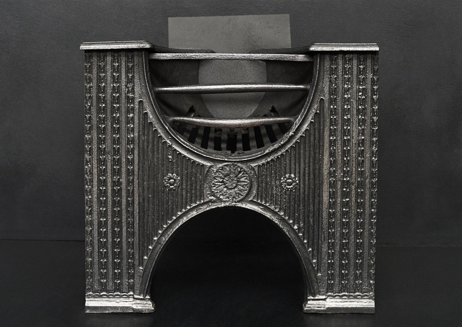 A decorative cast iron 'hour glass' hob grate. English, 19th century.

Width At Front:	545 mm      	21 ½