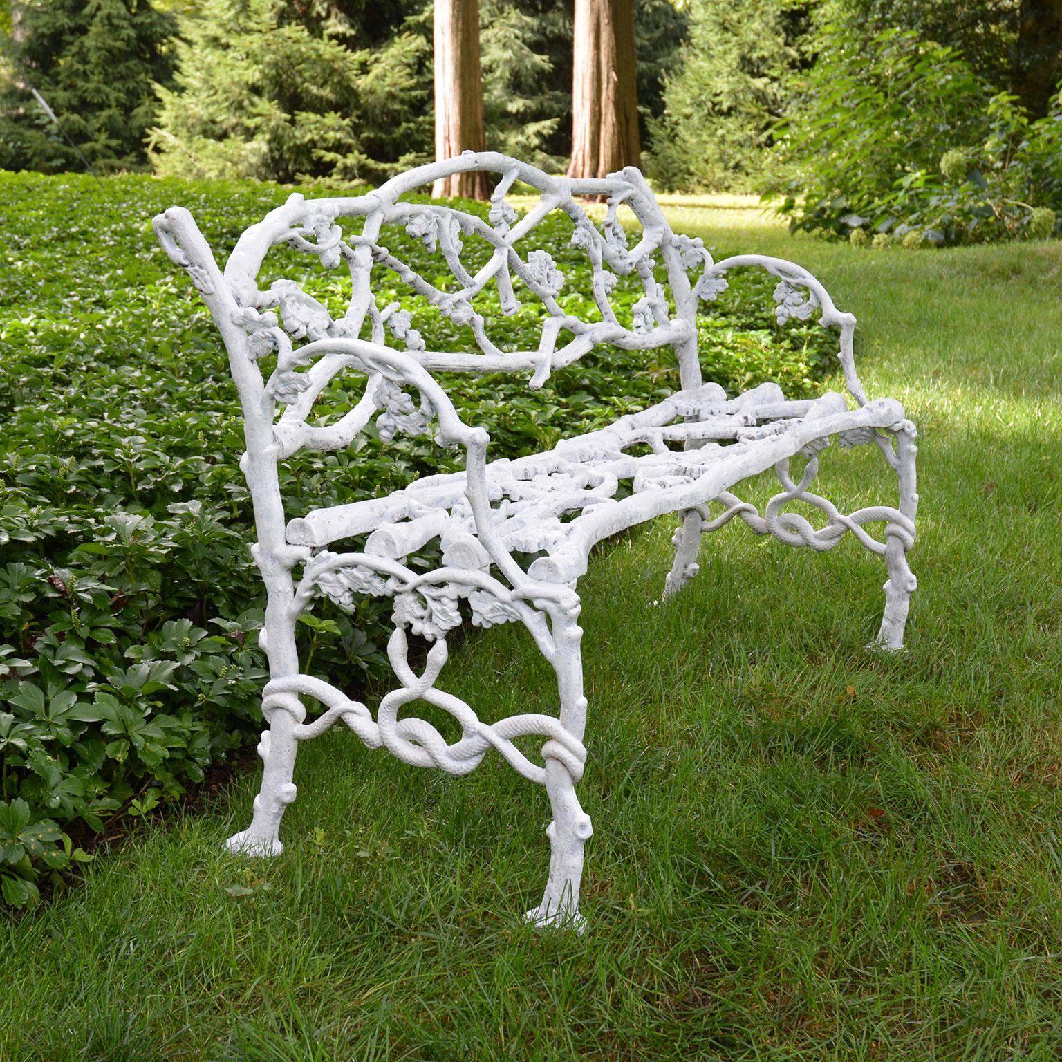 A fine “Oak Tree”, or rustic twig, pattern cast-iron seat, the naturalistic arched back, seat and arms cast as branches with acorn clusters, on conforming trunk feet joined by entwined serpents.