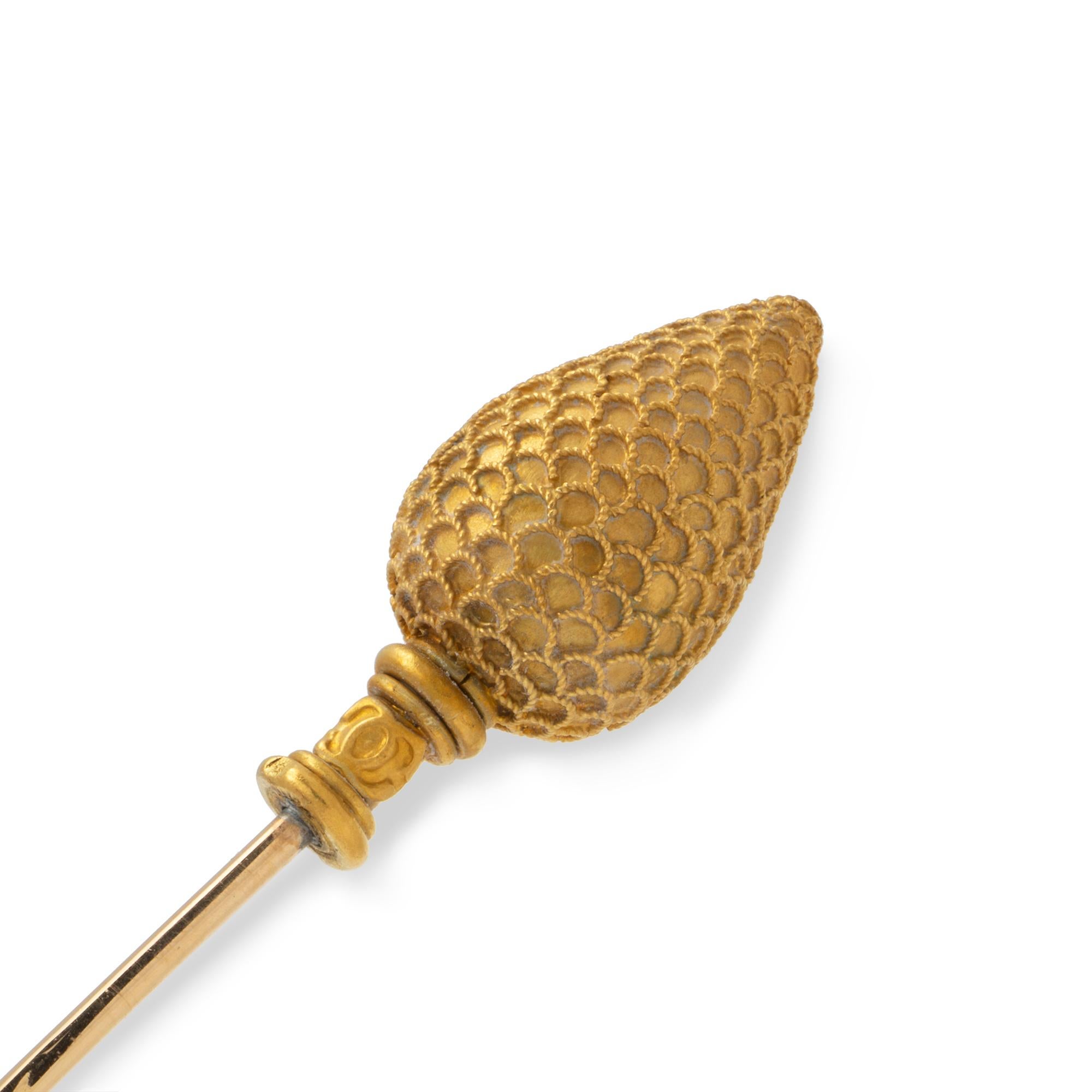 A Castellani gold stick-pin, the head in the form of a pine cone with twisted wirework decorations, bearing the double C’s hallmark on the base, all to a yellow gold pin, circa 1860, gross weight 4.7 grams.

A collectable stick pin in the form of
