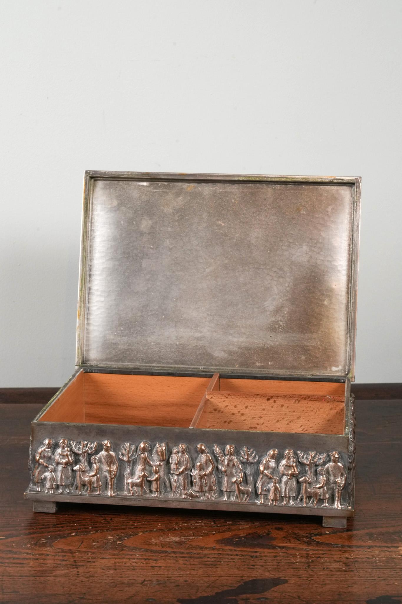 A cedar lined desk humidor by Magrit Tevan.

Silvered copper and brass, raised on block feet.

Wonderfully patinated throughout, fabulous desk piece.