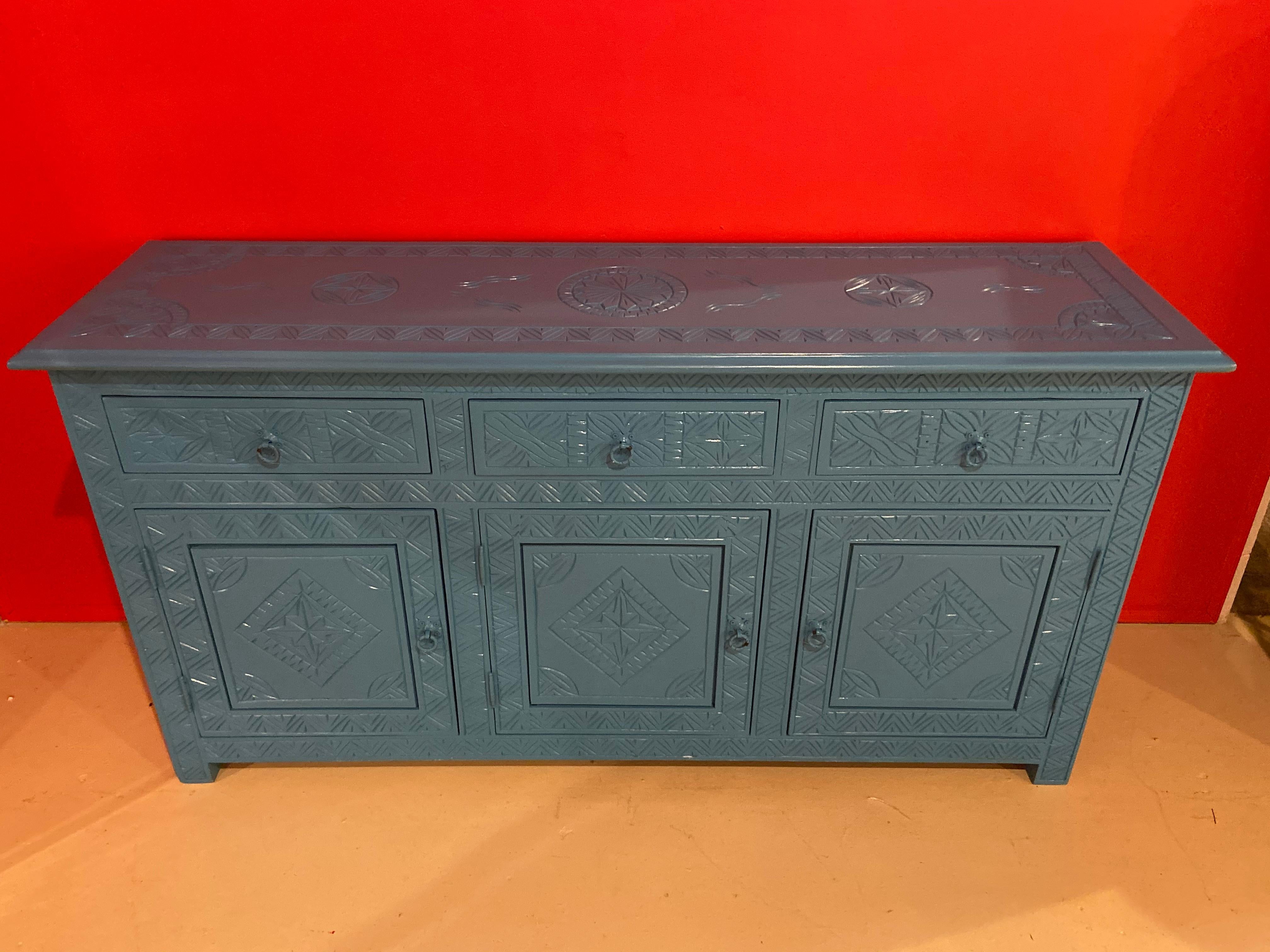 A true exemplary work of hand carved wood work, this modern Moroccan beautiful celeste blue console is a perfect combination of style and usefulness. The dresser or console features three drawer over three doors, so plenty of storage. The celeste