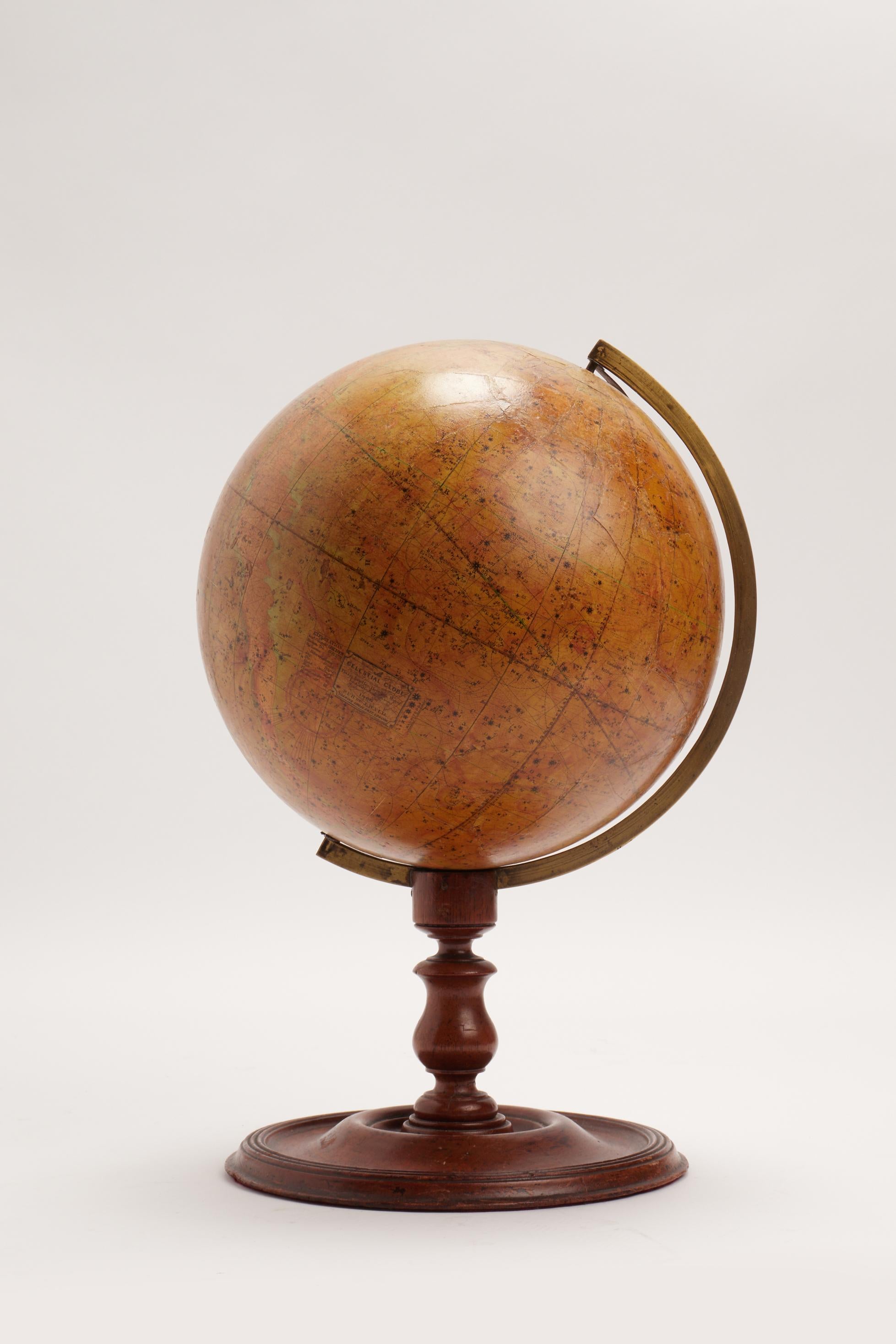 Over a wheel turned Mahogany wooden base, with the round foot, moved profile and tall leg, with a perfect patina, is placed this celestial globe, edited by J. Wyld, Charing Cross East, London. The globe is made out of paper maché, finished with