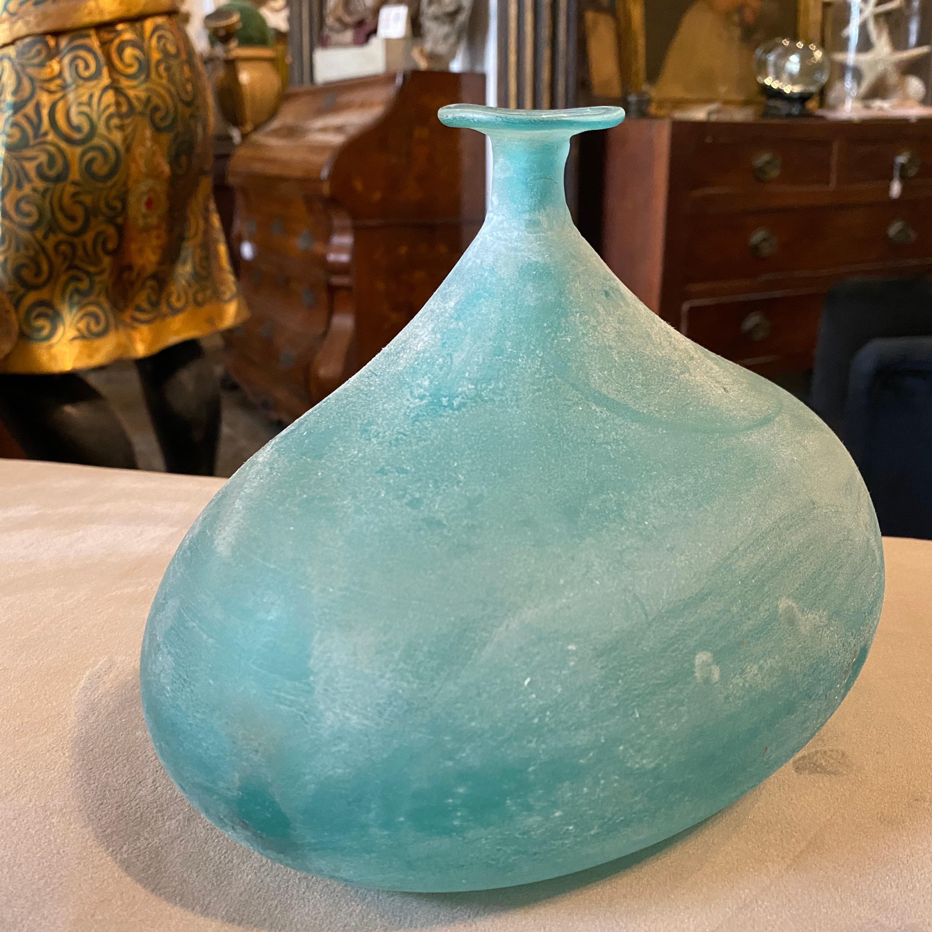 Amazing hand-crafted blue vase made in Murano by Cenedese, it's signed and labeled on the bottom. It's a very particular blue vase for its irregular shape, this type of glass is named 