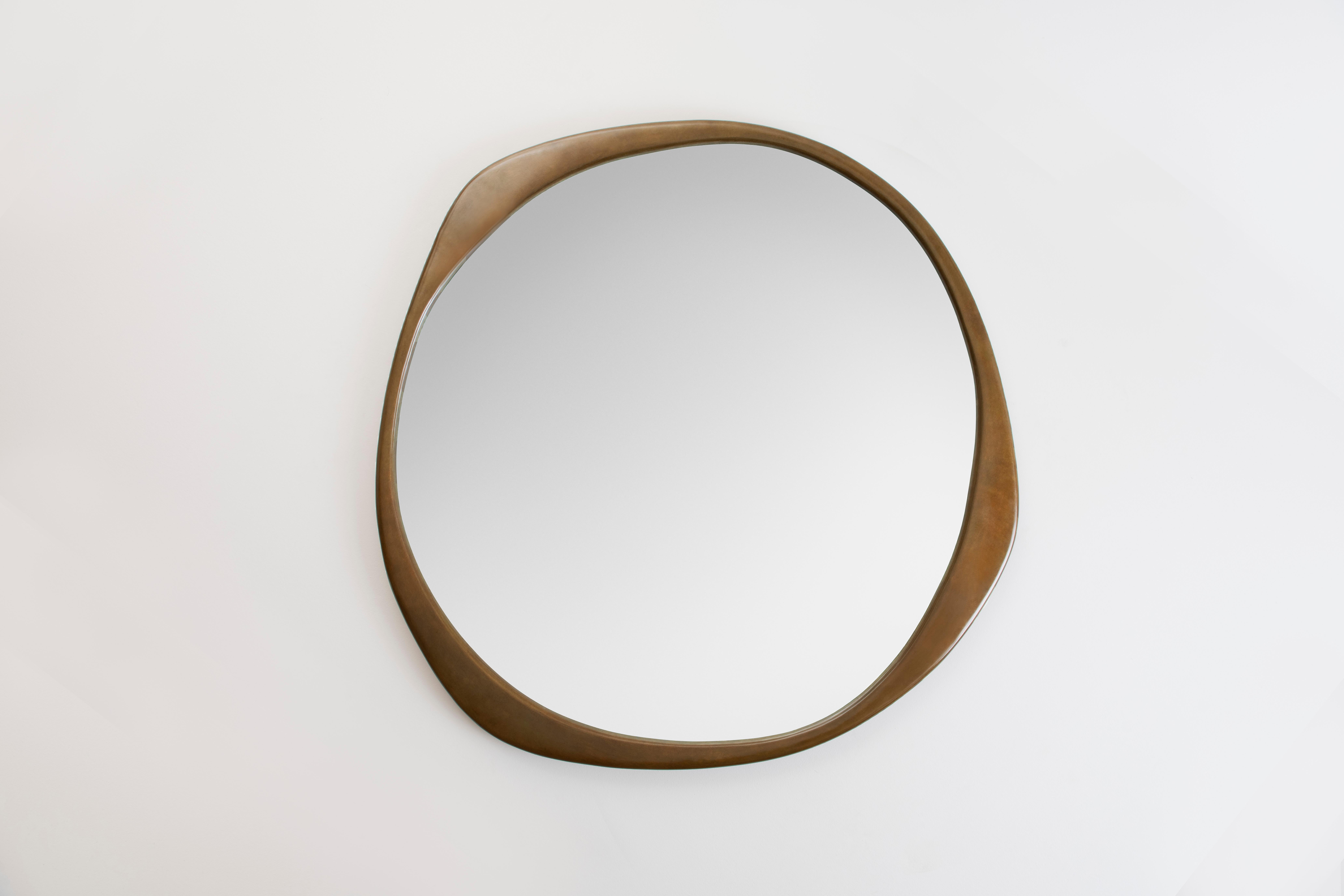 The sculptural A.Cepa mirror in hand-patina bronze is cast in bronze at a fine art foundry in Pennsylvania, and skillfully finished by hand. Undulating and irregular in form, the A. Cepa mirror is the focal point in any room with its captivating
