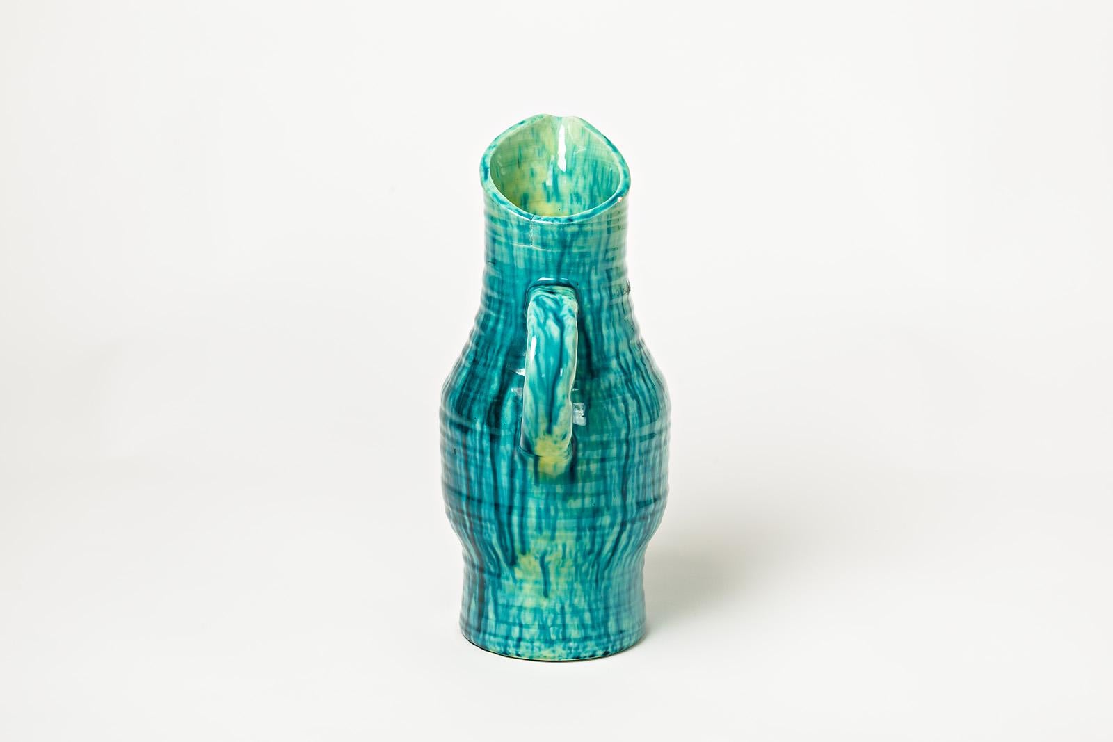 A ceramic pitcher by Accolay with green, blue, yellow glazes decoration.
Perfect original conditions.
Signed under the base,
circa 1960-1970.