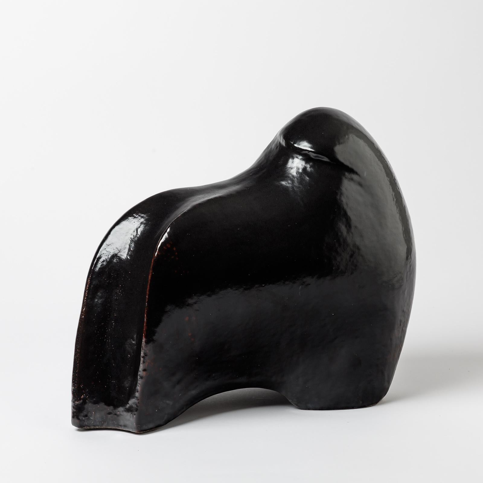 A ceramic sculpture with black glaze decoration entitled 