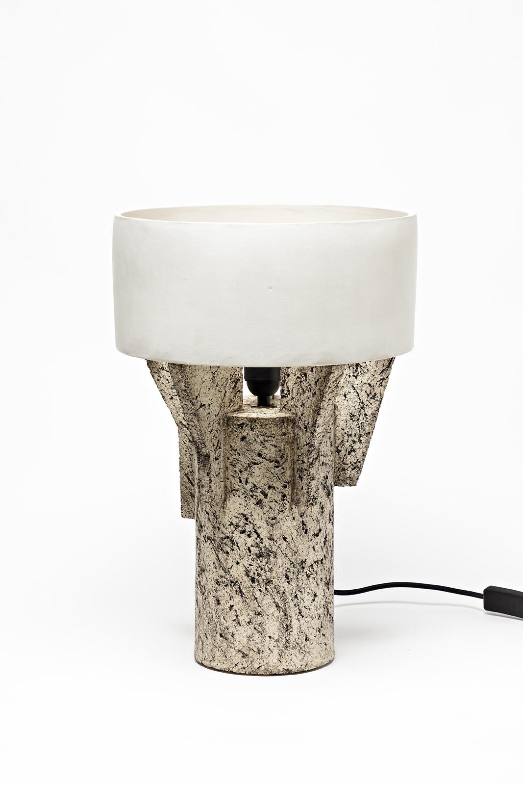 A ceramic table lamp by Denis Castaing with white glaze decoration.
The base and the lamp shade are in ceramic.
Sold with a European electrical system.
Perfect original conditions,
2019.
Signed under the base.