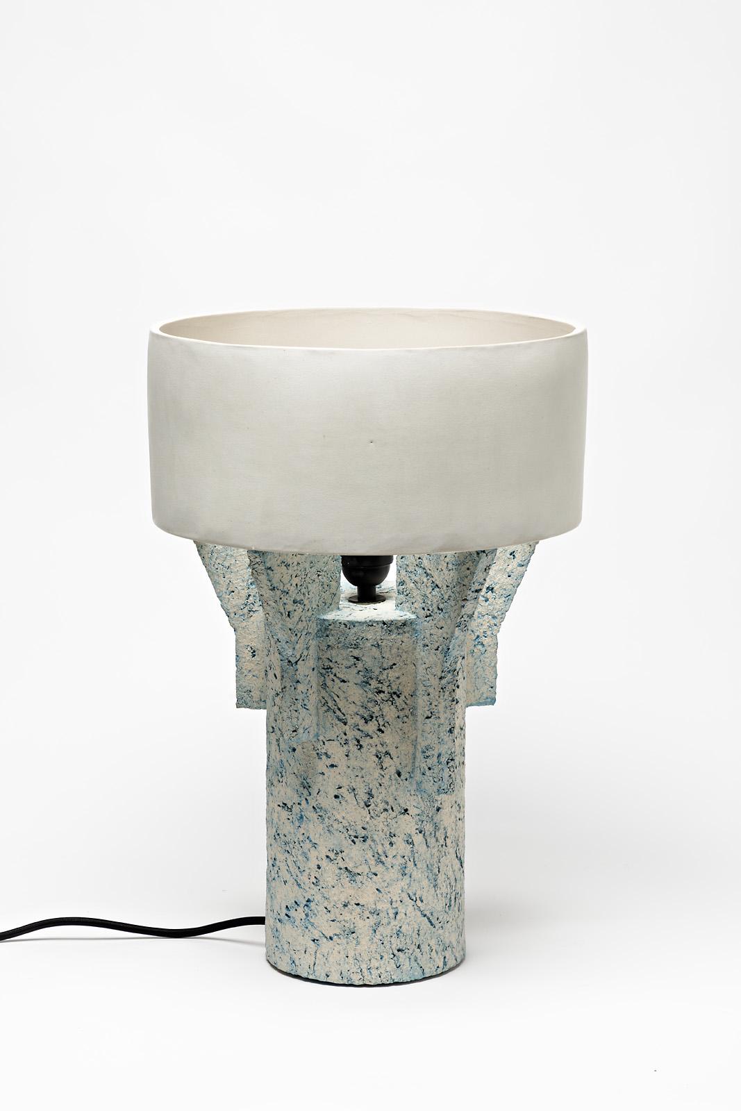 A ceramic table lamp by Denis Castaing with white glaze decoration.
The base and the lamp shade are in ceramic.
Sold with an European electrical system.
Perfect original conditions.
2019.
Signed under the base.