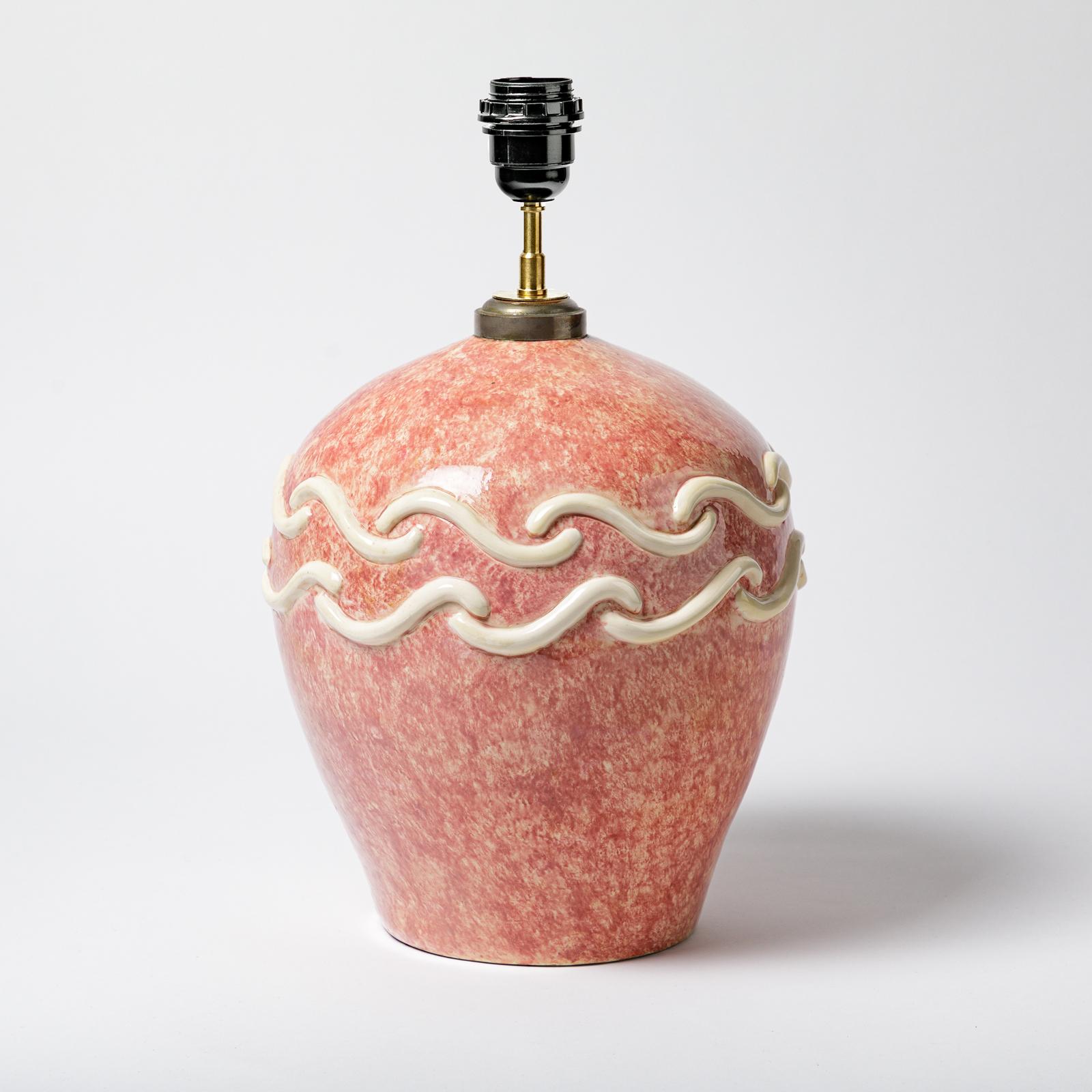 A ceramic table lamp with pink and white glaze decoration attributed to Sainte Radegonde. 
Perfect original conditions.
Circa 1930.
Sold with a new European electrical system.
Dimensions are mentioned for the ceramic only.