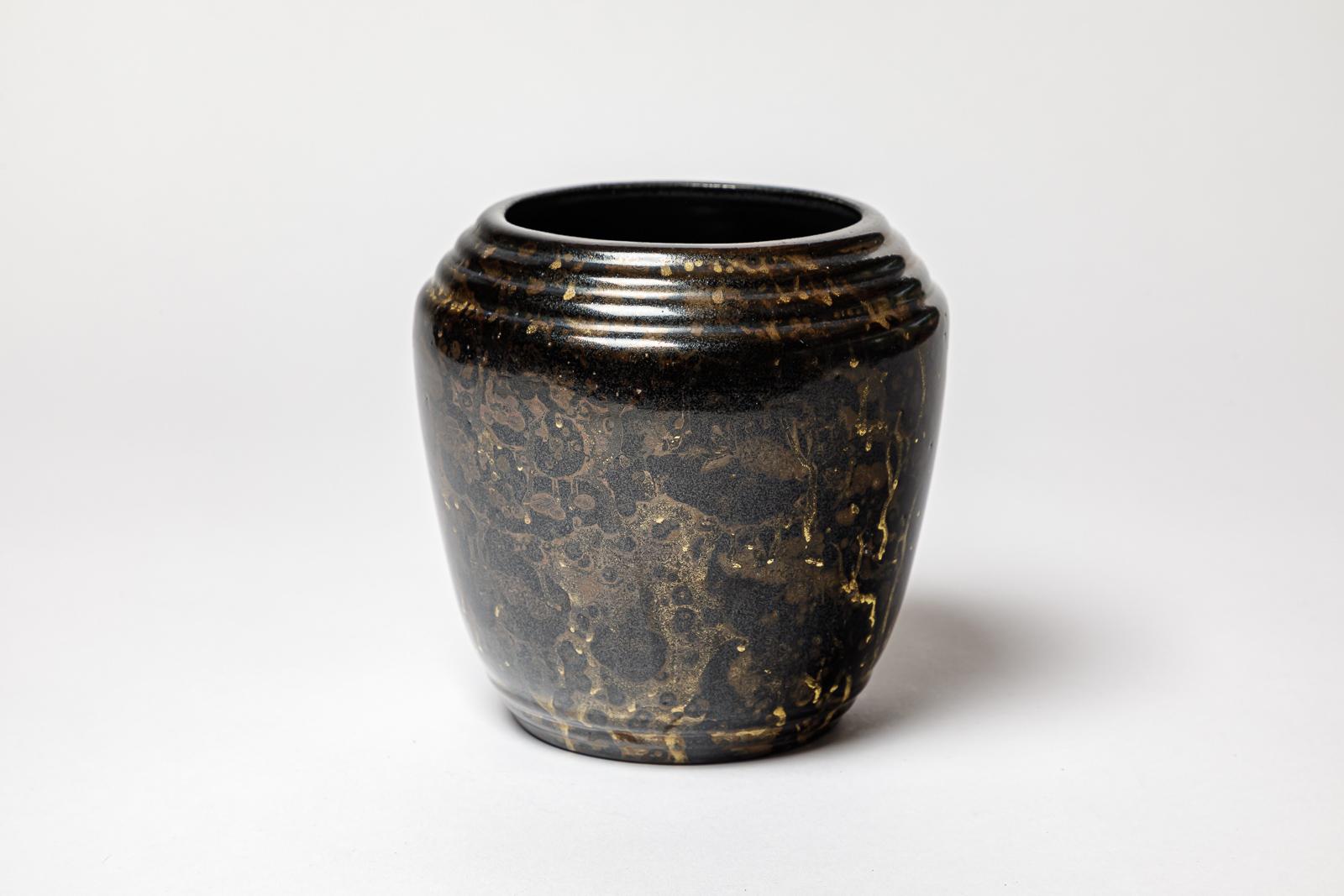 Un vaso in ceramica color oro e marrone-nero  decorazione con smalti di Lucien Brisdoux.
Firma dell'artista sotto la base 