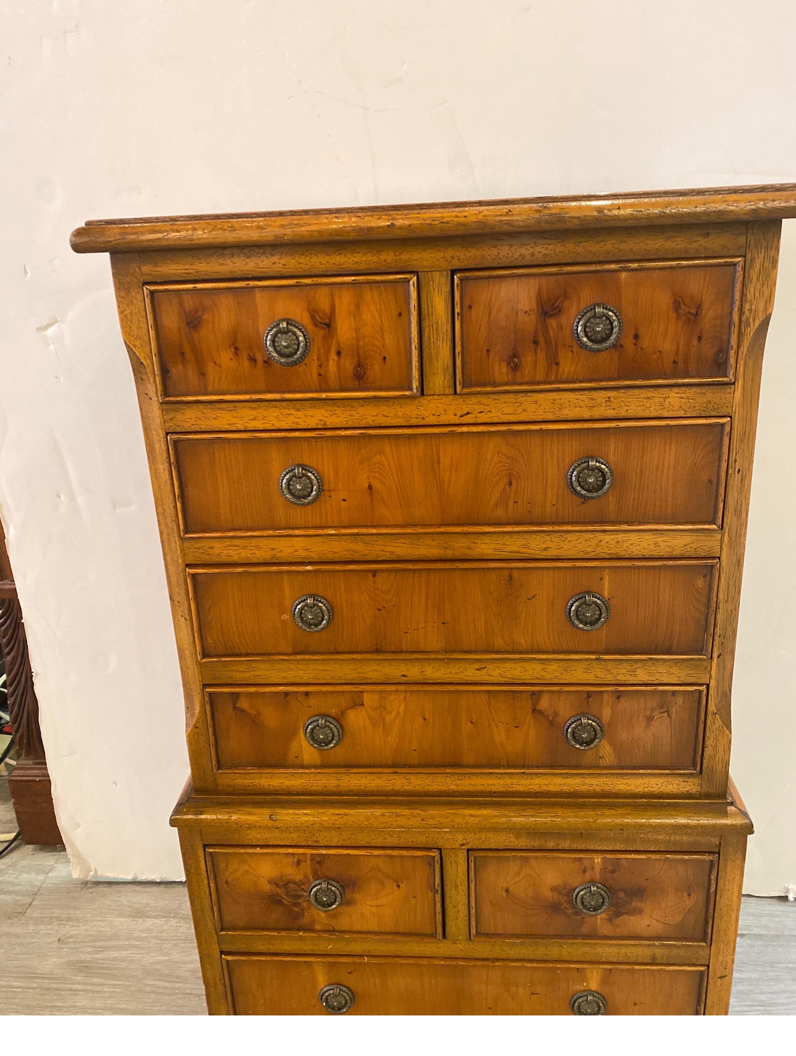 This English made chair side chest is 31 inches tall, made in London of yew wood. This very functional side chest with working drawers is perfect as a night stand, or by on chair with a lamp. Marked inside the upper drawer 