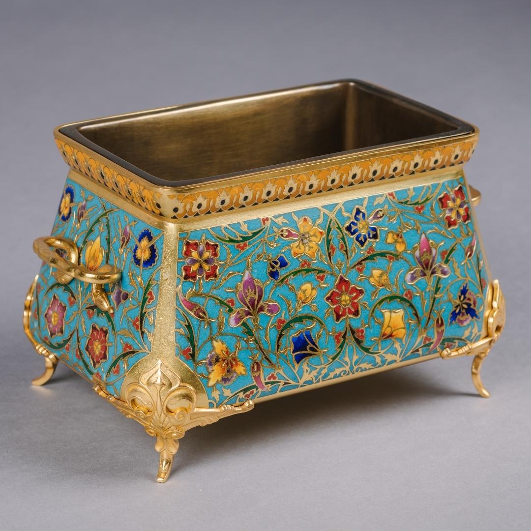 A Champlevé Enamel and Gilt-Bronze Mounted Jardinière by Ferdinand Barbedienne, the design attributed to Louis-Constant Sévin. This fine jardinière is decorated all over with foliate scrolls and polychrome enamel flowers on a turquoise background. 