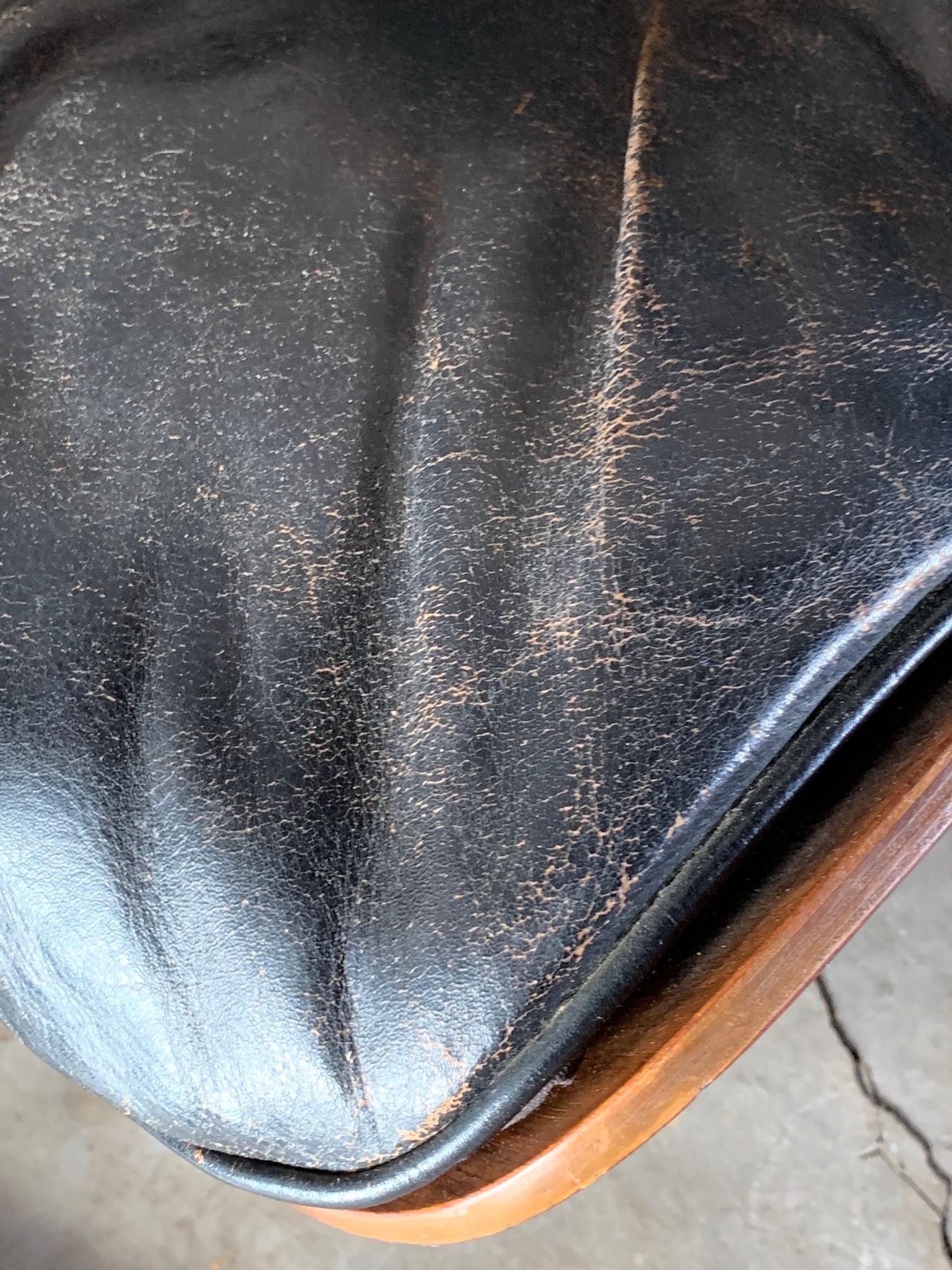 A Classic first year of production-1956 Charles Eames for Herman Miller lounge chair and ottoman, known as 670 and 671. Black leather and rosewood, with rare foil label. Three screw configuration and slip on boot glides. This a rare example with