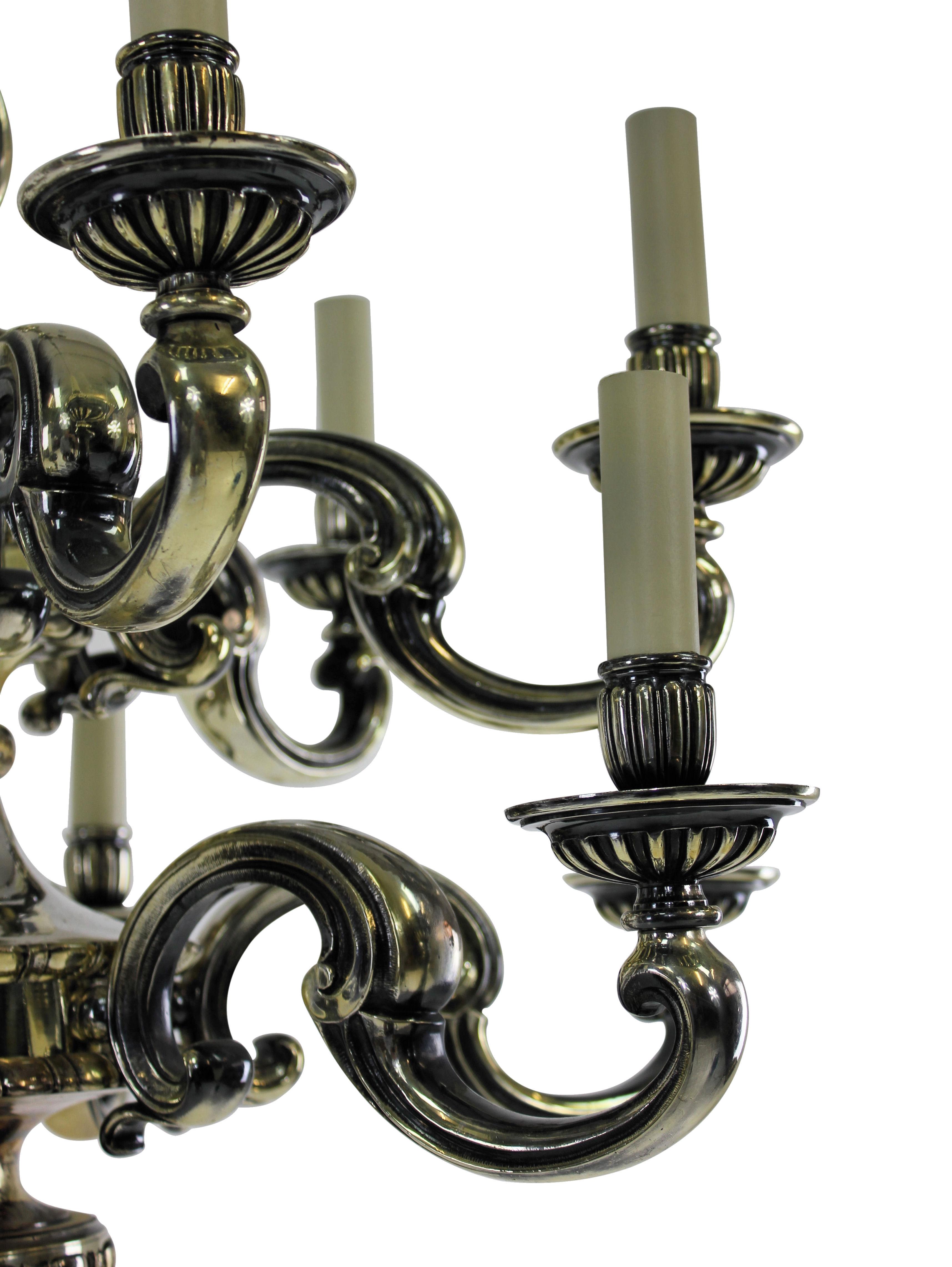An English silver plated bronze chandelier of fine quality in the Charles II style comprising two tiers and twelve lights in total.

Newly electrified.