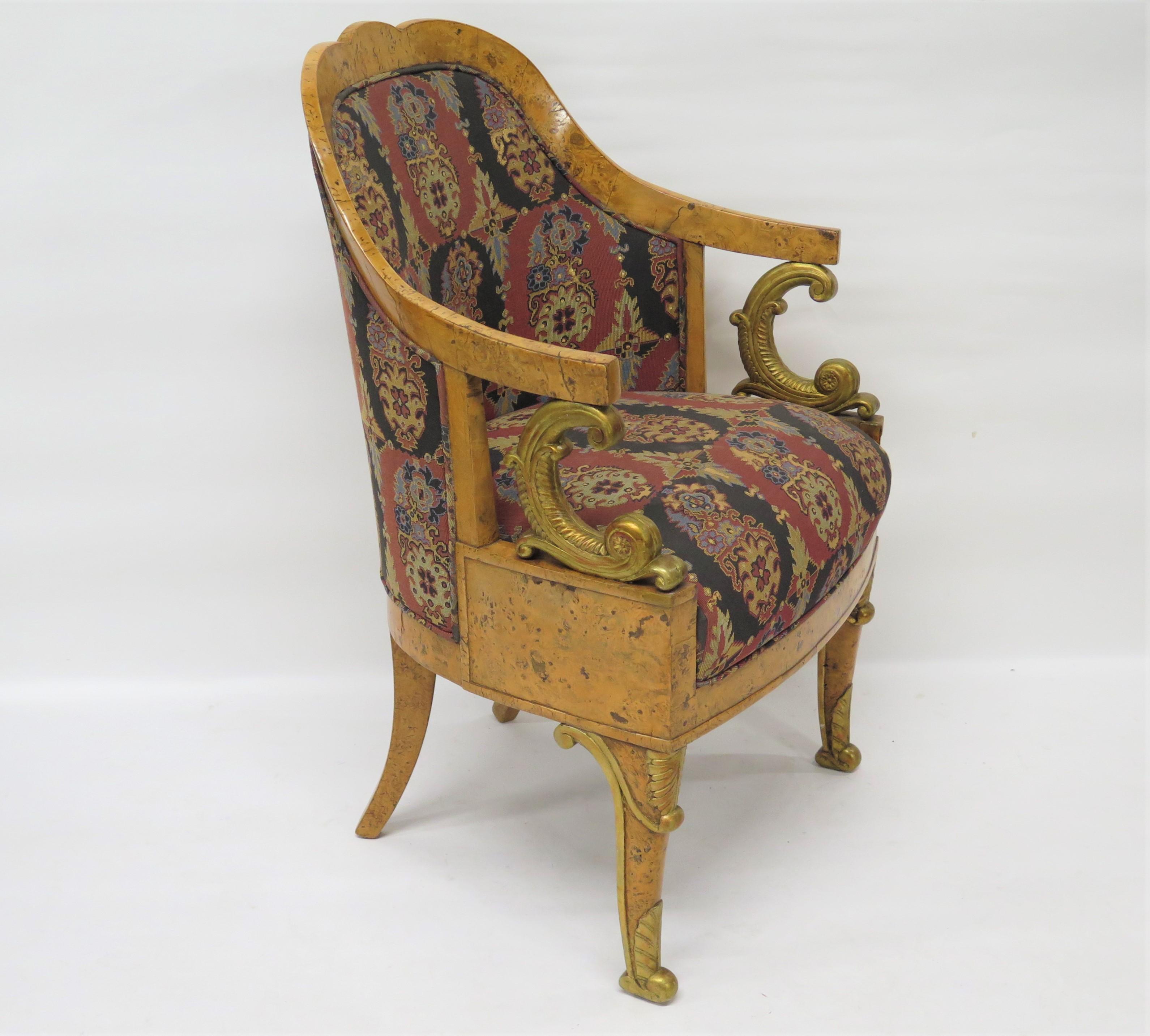 a Charles X birch tub form arm chair featuring elegantly curved gilt arms and legs. France, circa 1825   

38.25