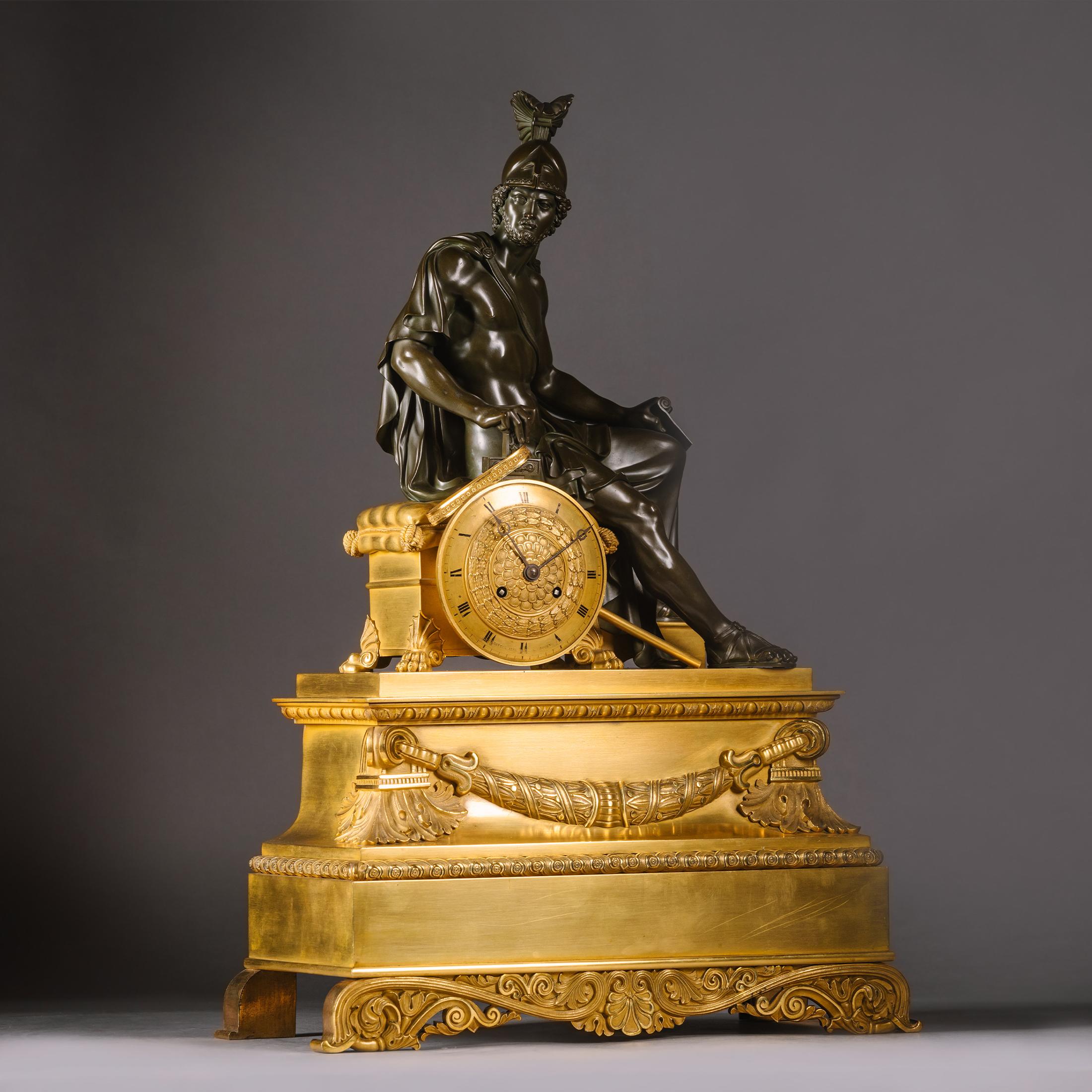 The dial signed 'Ritter Aîné à Rouen',

The case surmounted by a seated figure of Mars holding a scroll marked 'Marathon', seated on a cushioned throne with lion-paw feet, below him is a circular dial relief-cast with laurel and Roman numerals,