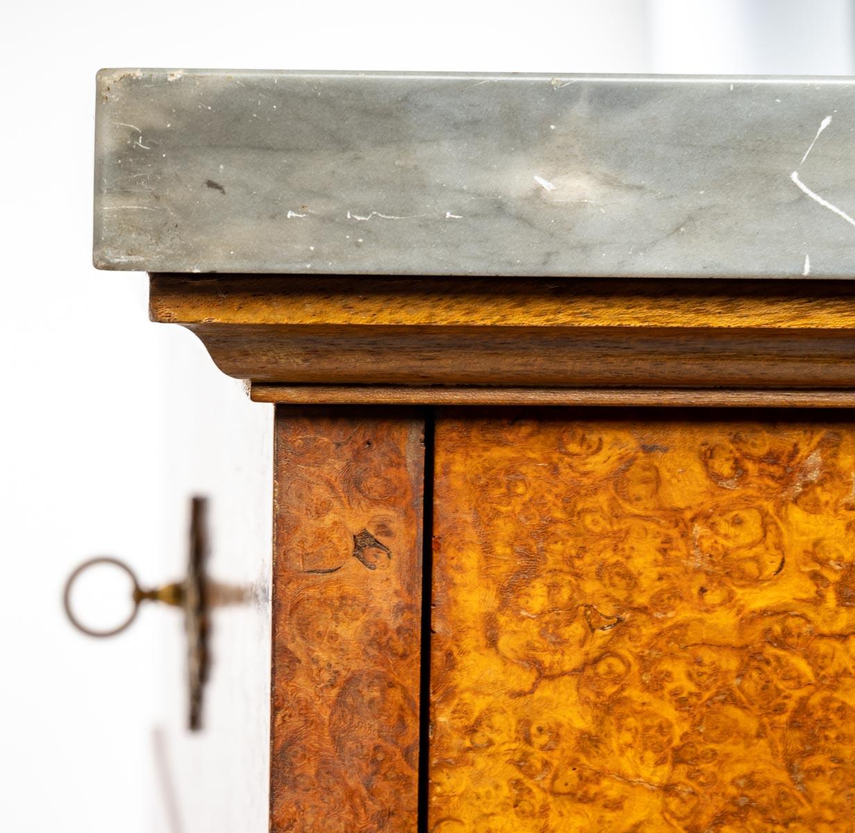 A Charles X style burr-walnut and bronze small desk, grey marble top, 1930, 4 drawers and a desk storage, with its keys.
Measures: H: 120 cm, W: 66 cm, D: 38 cm.