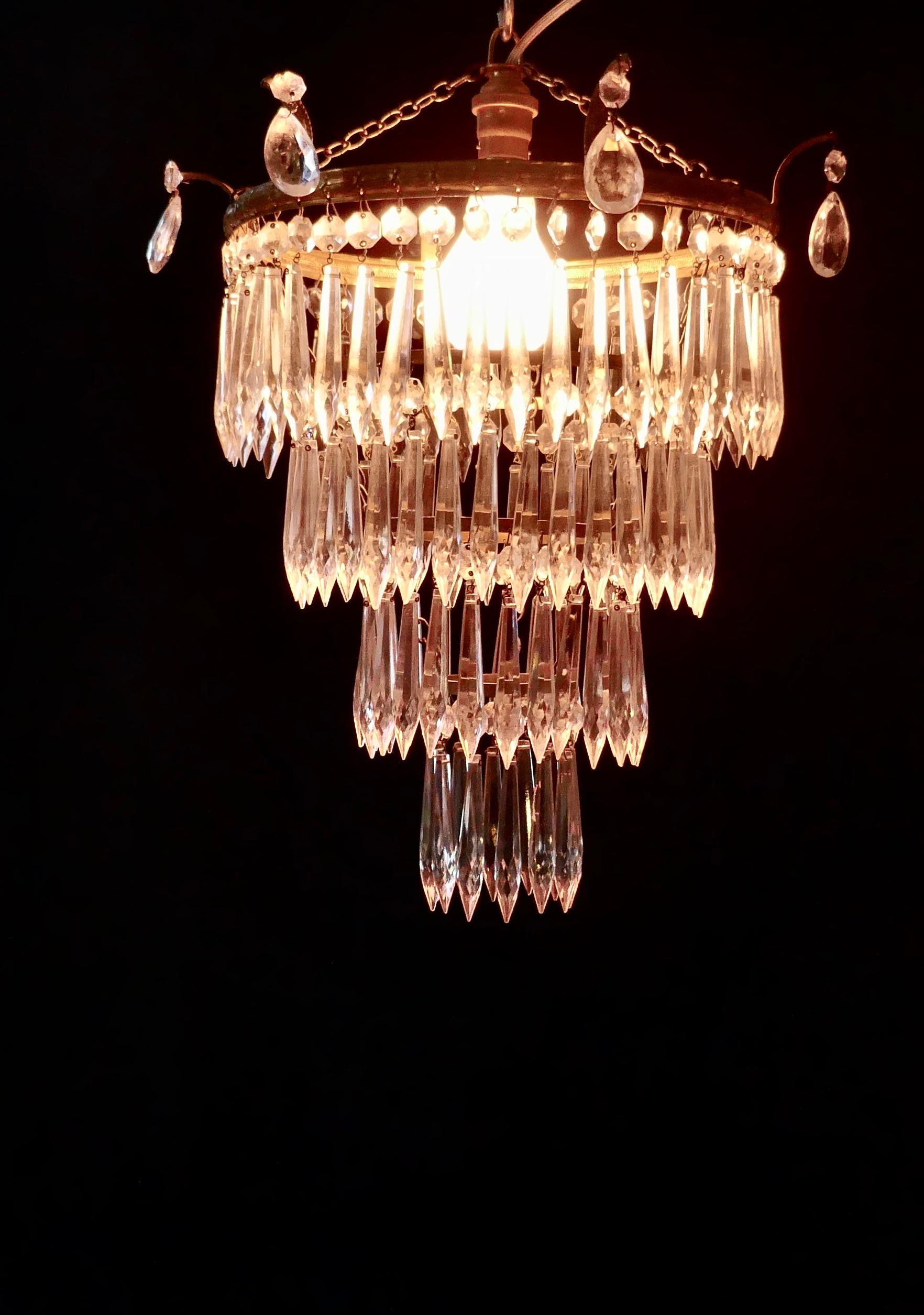A charming Art Deco 4-tier waterfall pendant chandelier


A charming waterfall tiered pendant chandelier, this delicate light has four layers of crystal icicle pendants hanging from a circular brass age darkened frame 

This fine quality
