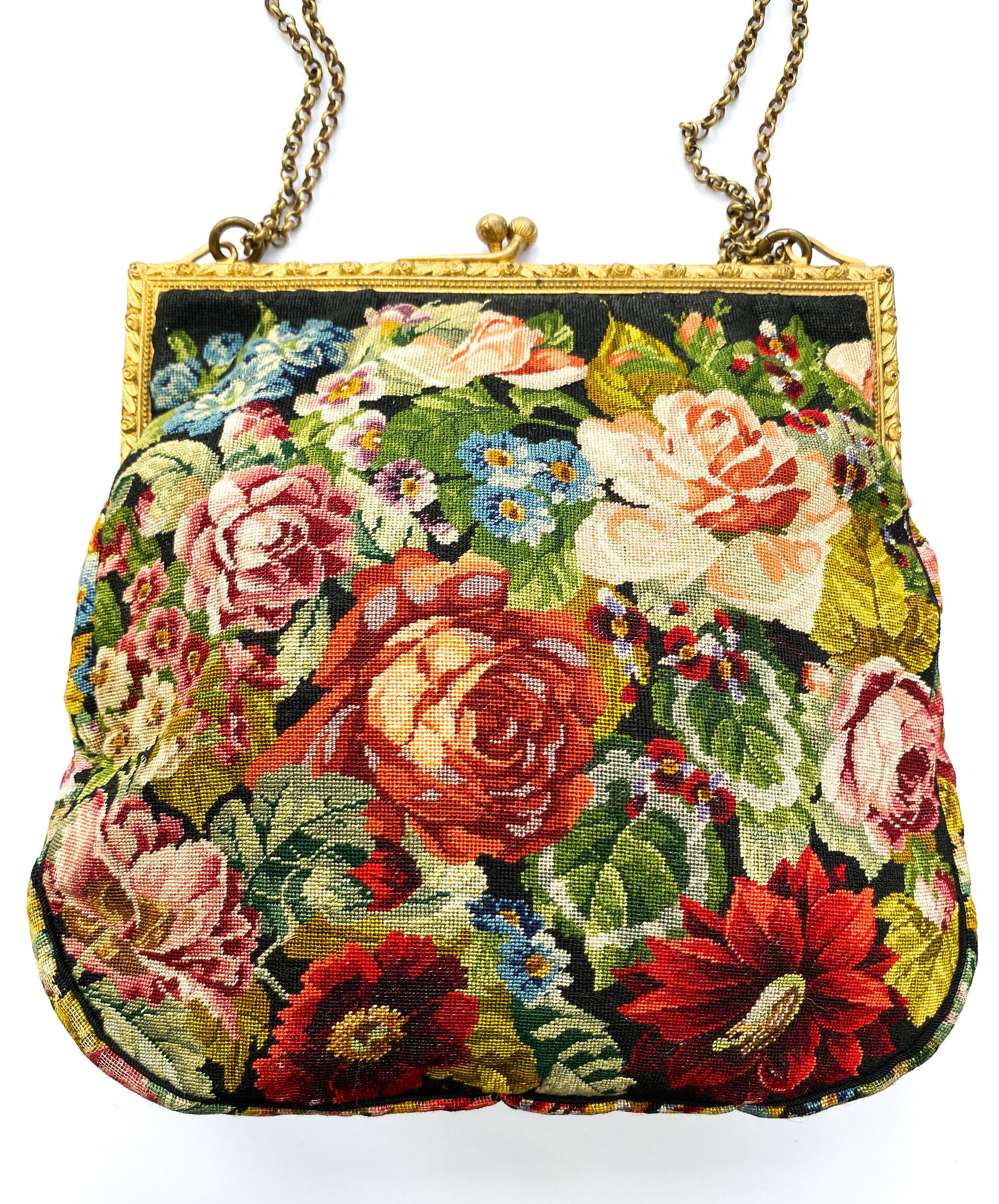 A charming and highly attractive handbag, perfect for evening or that special occasion. the needlepoint is of the highest and finest quality with roses and a variety of other flowers, and foliage on both the front and back and gusset. The frame is