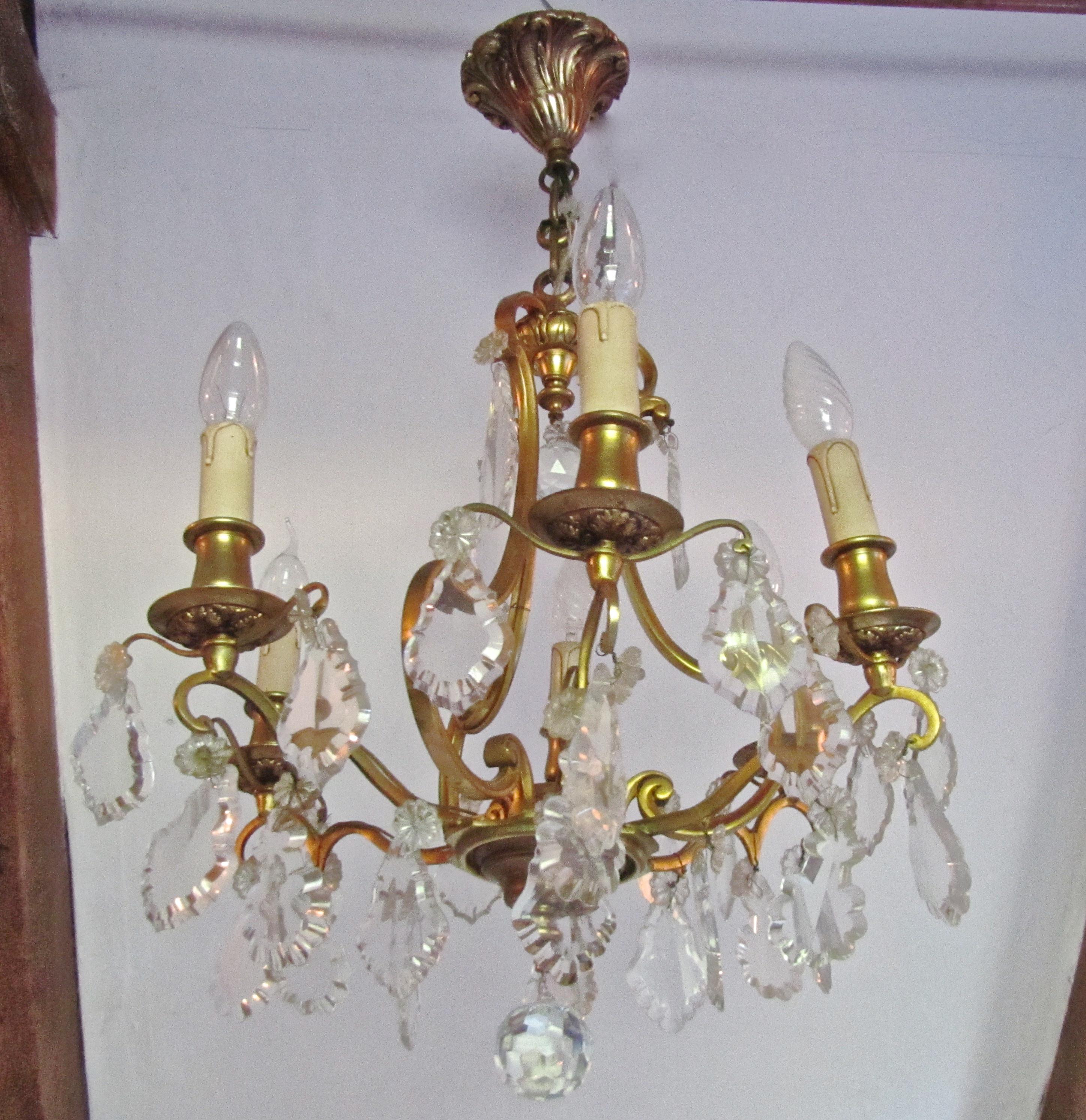 A charming French cut glass and brass 6 branch chandelier

This is an excellent quality and very dainty piece, the brass has a gilded finish and the 6 arms are hung with faceted glass tear drop pendants and tiny rosettes it has an attractive