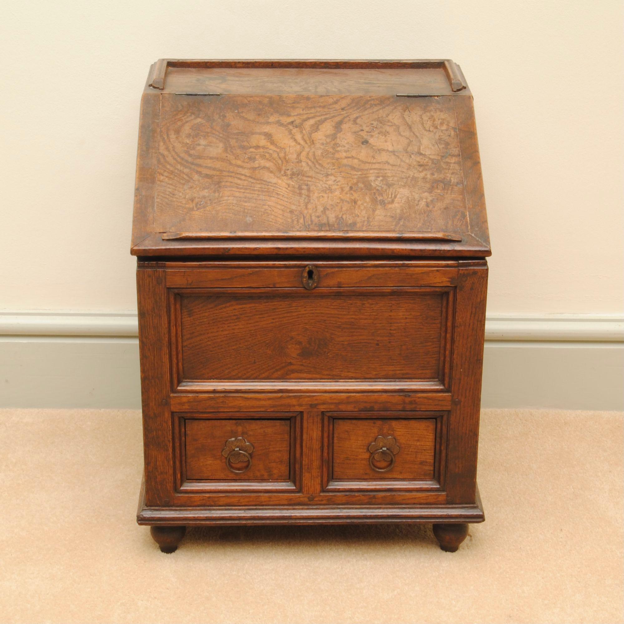 A super early 18th-century childs writing desk, the slope top lifts to reveal a fitted drawer; of lovely colour and patina.