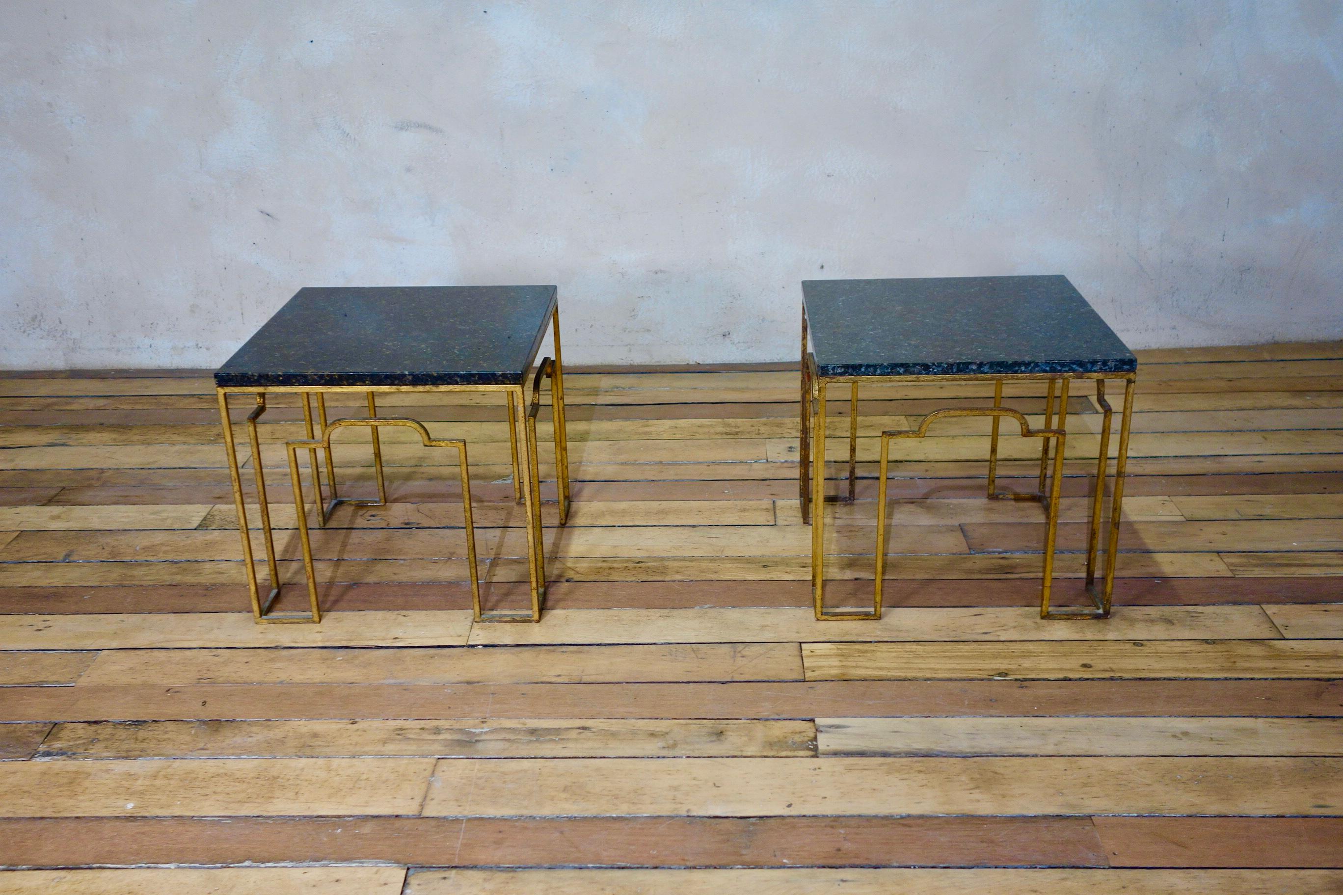 An exceptional pair of early 20th century gilt metal occasional tables. Demonstrating a striking and simplistic design to the square tubular base, with a rich and warm patination to the gilt metal. Each featuring a removable square grey-black