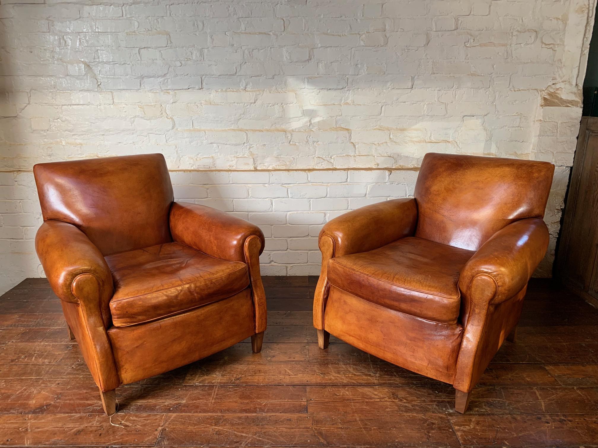 
A Charming Pair of English Leather Club Chairs Circa 1920’s

This lovely and inviting pair of English leather club chairs is in a gorgeous condition. The chairs have benefitted from being reupholstered approximately 30 years ago, meaning they not