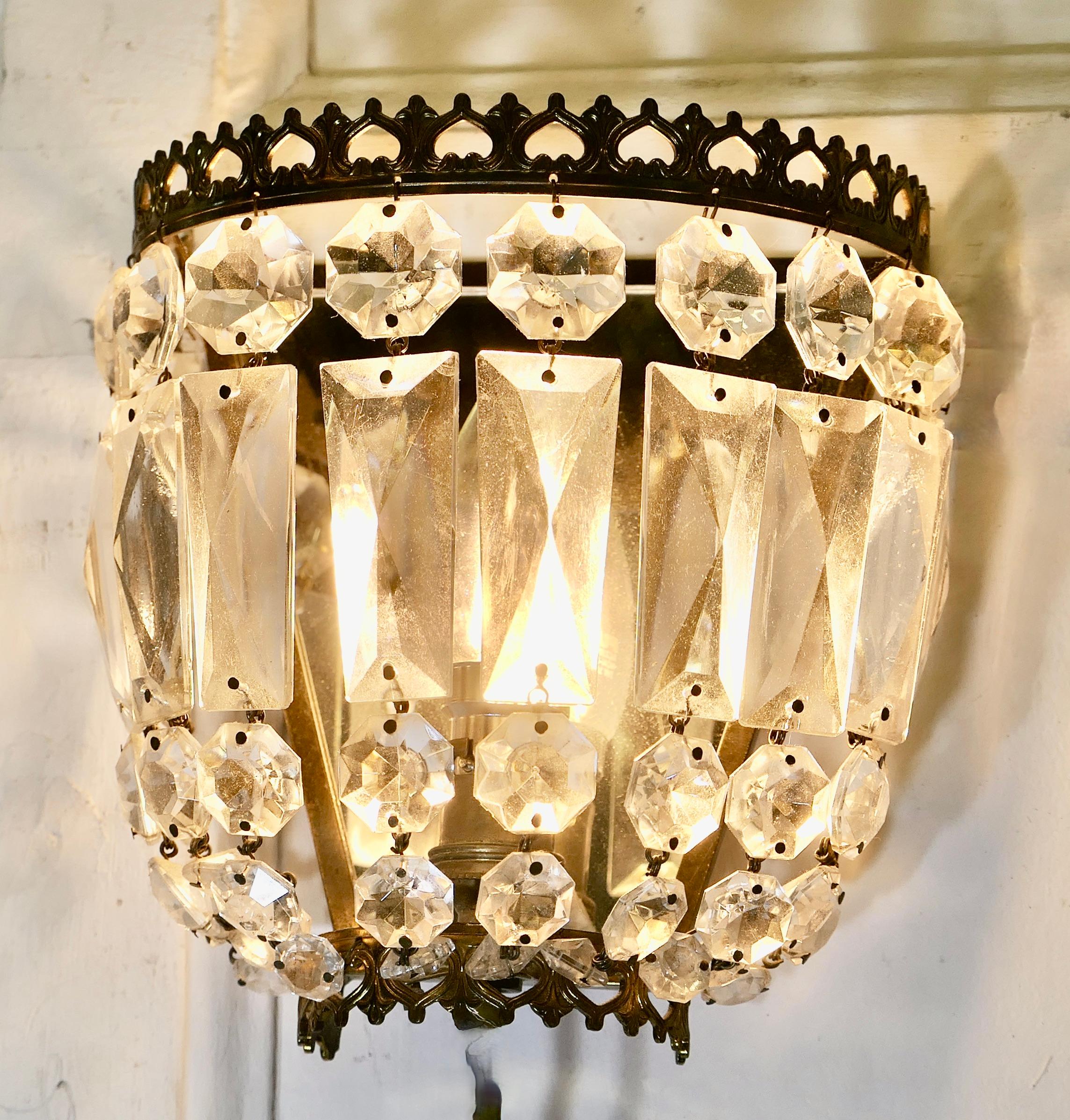 A Charming Pair of French Basket Chandeliers Wall Appliqué 


A Charming pair of wall lights they are hung with a  layer of cut glass faceted pendants hanging from a brass frame

These Dainty Chandeliers are fitted with a bayonet which requires
