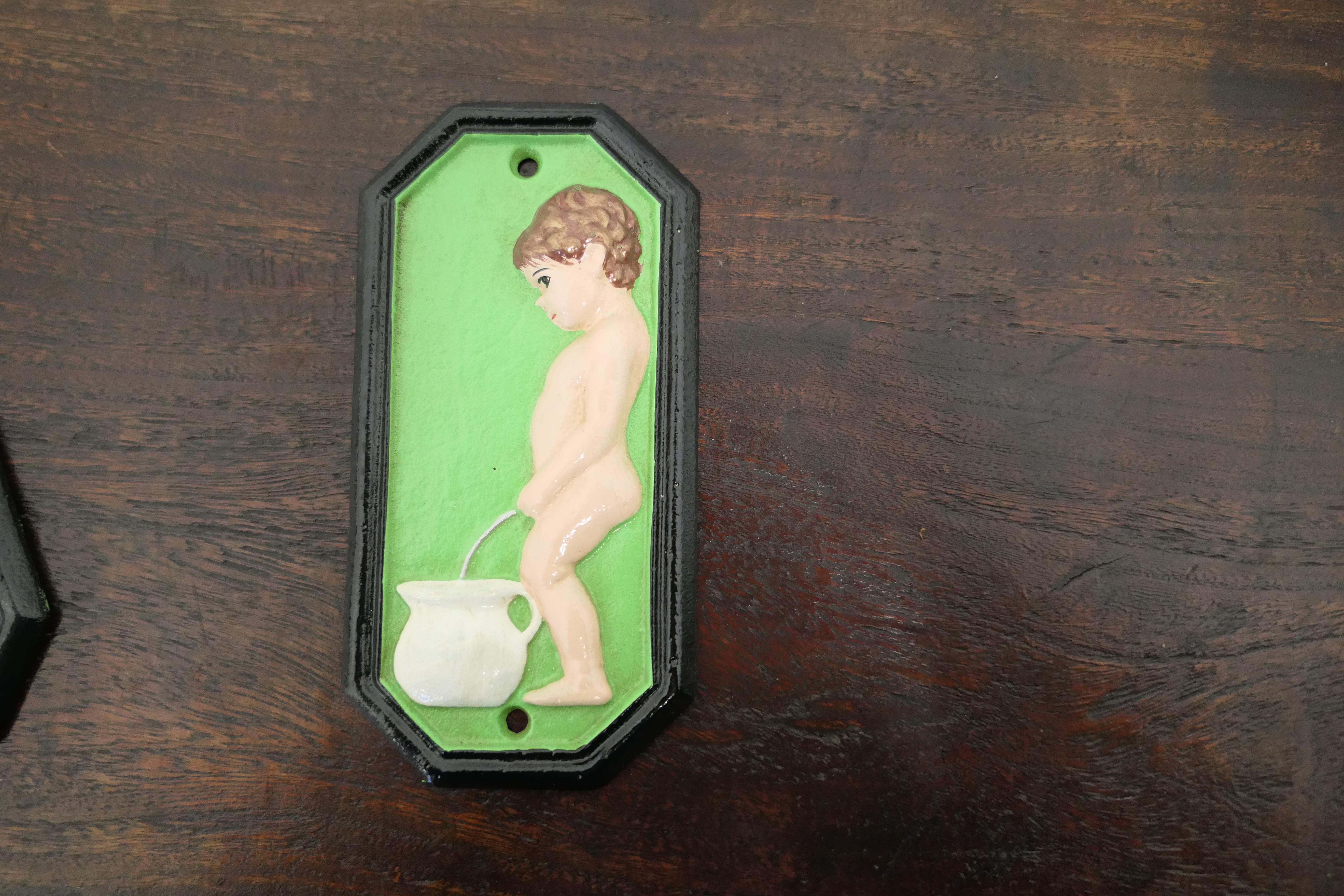 A charming pair of male and female toilet signs.

Ladies and Gentlemen, Boys and Girls no home should be without these, painted Cast iron Loo signs. 

The signs are 7” high, 3.5” wide and 1” thick, painted in green with very little wear.
TCC198