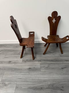 A charming pair of Spanish arts & crafts occasional solid oak chairs