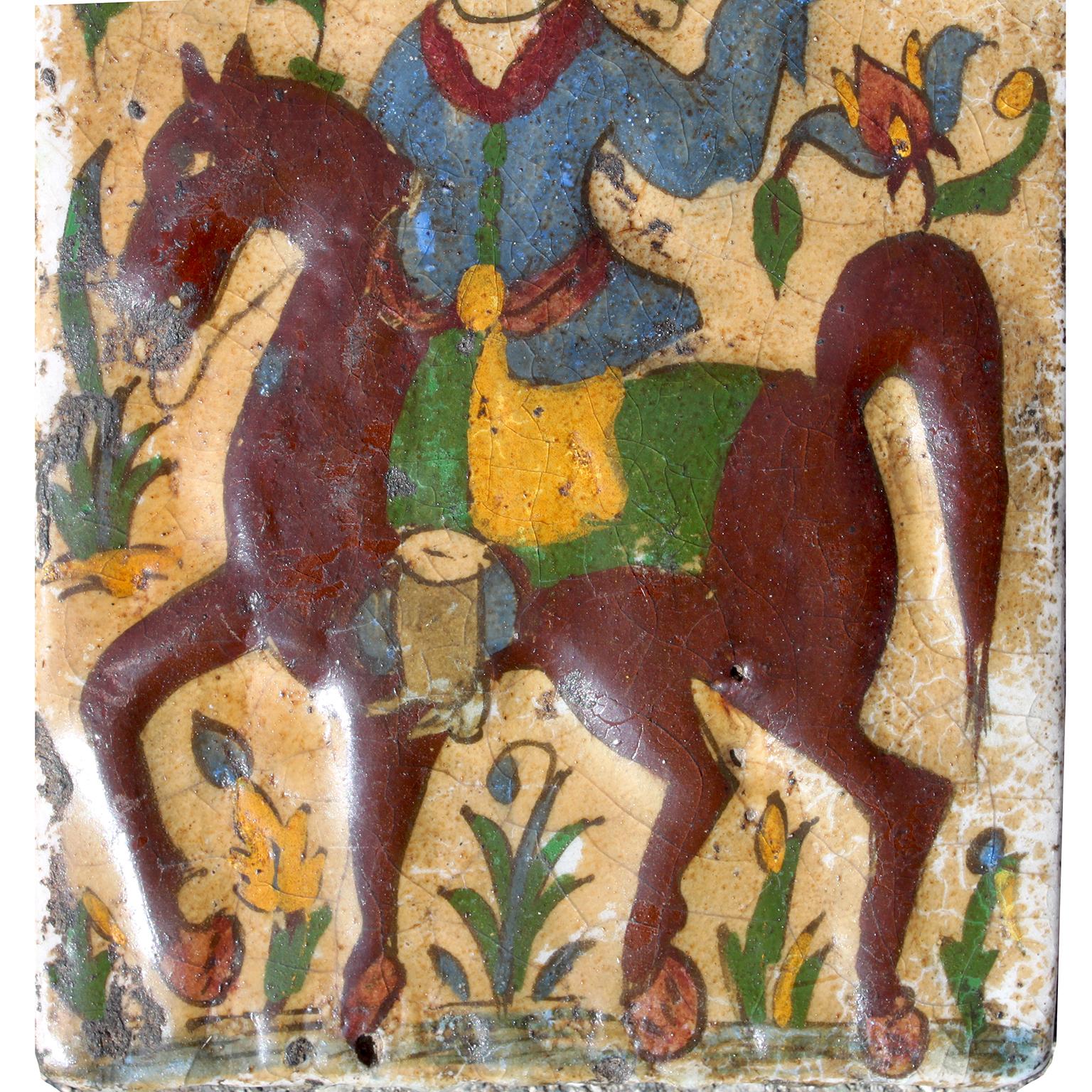 A Charming Persian Qajar Glazed Moulded Pottery Tile of a Falconer or Bazdar In Fair Condition For Sale In Los Angeles, CA