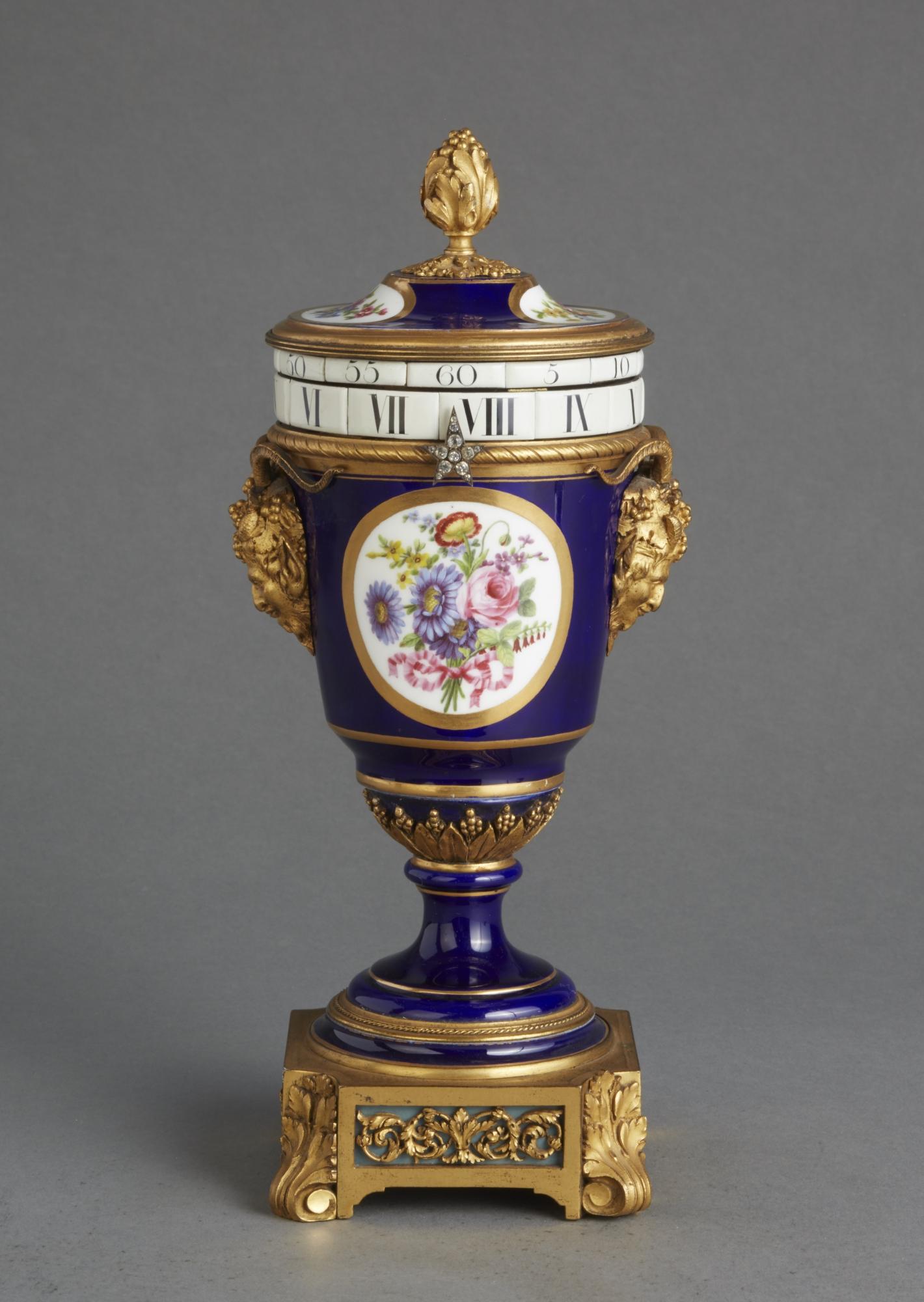 
The beautiful proportions and the typical Sevres blue color and flowers are of a very high quality.

Mounted with beautiful cast fire gilt bronzes and a lovely hand in the form of a star with crystals.

The 8-day striking movement with two rotating