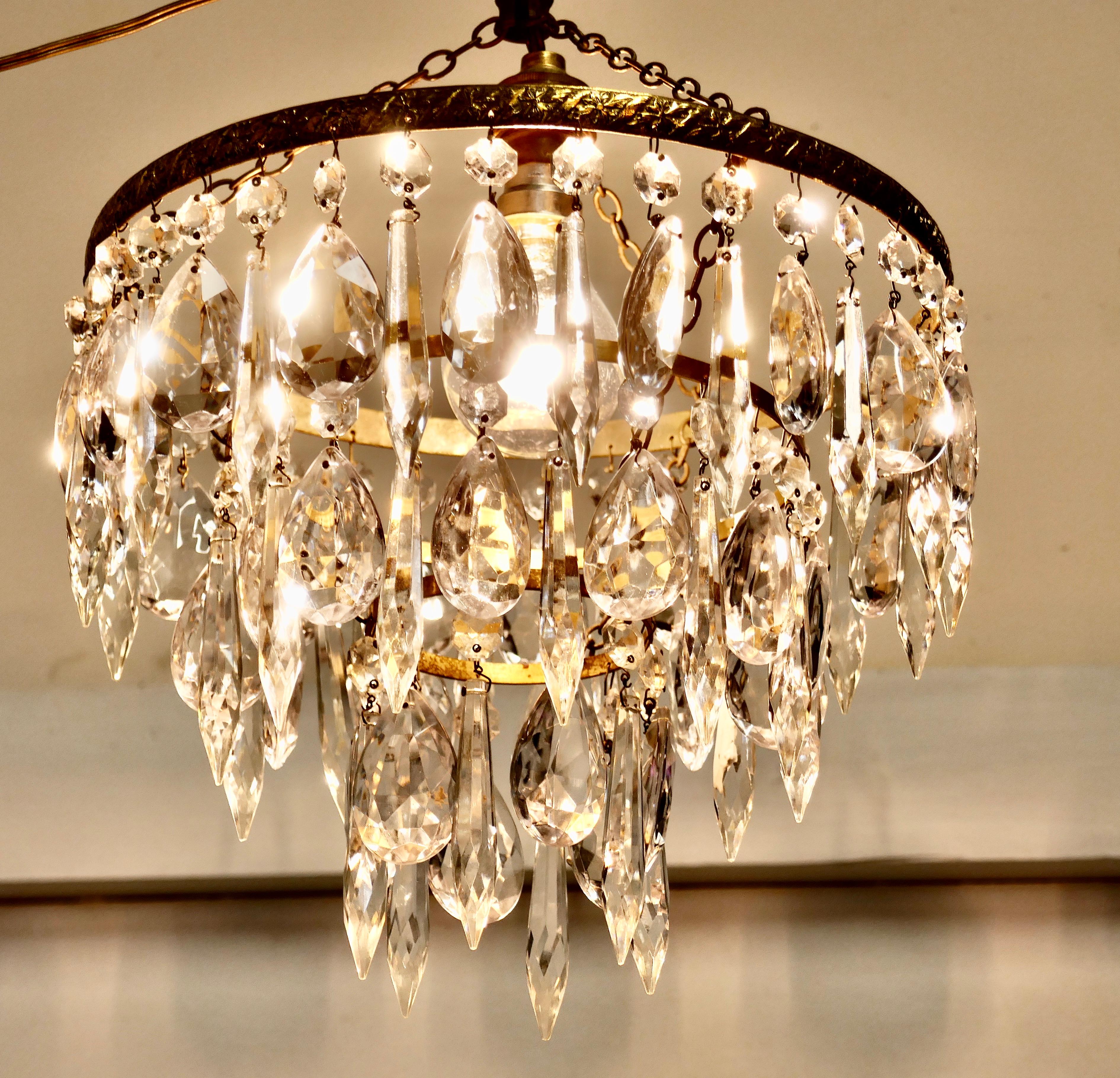 A Charming Waterfall 3 Tier Pendant Chandelier

A Charming waterfall tiered pendant chandelier, this delicate light has three layers of 3 of alternating faceted cut glass pendants with tier drops hanging from a brass frame 

This Dainty Chandelier