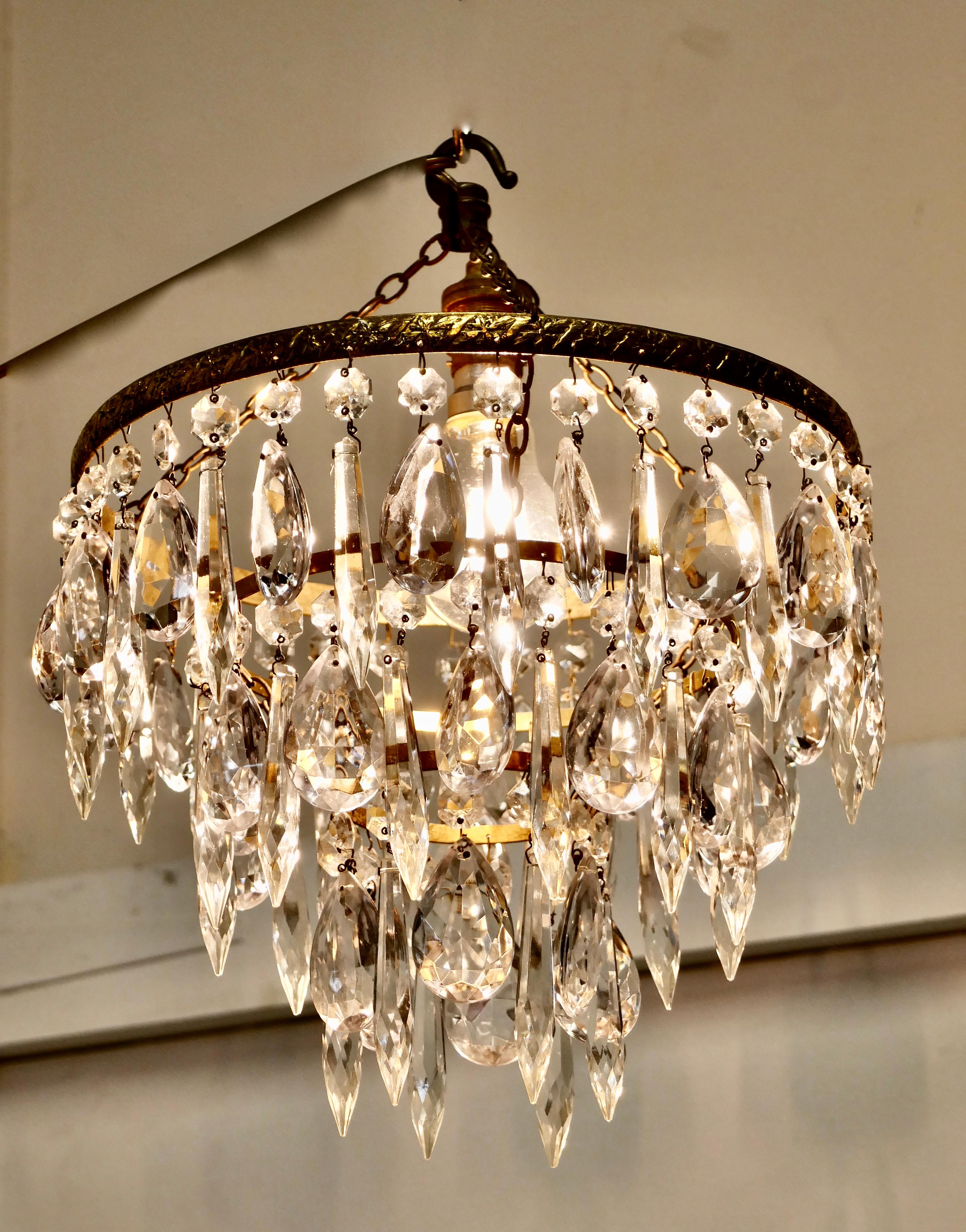 A charming waterfall 3-tier pendant chandelier

A charming waterfall tiered pendant chandelier, this delicate light has three layers of 3 of alternating faceted cut glass pendants with tier drops hanging from a brass frame 

This Dainty