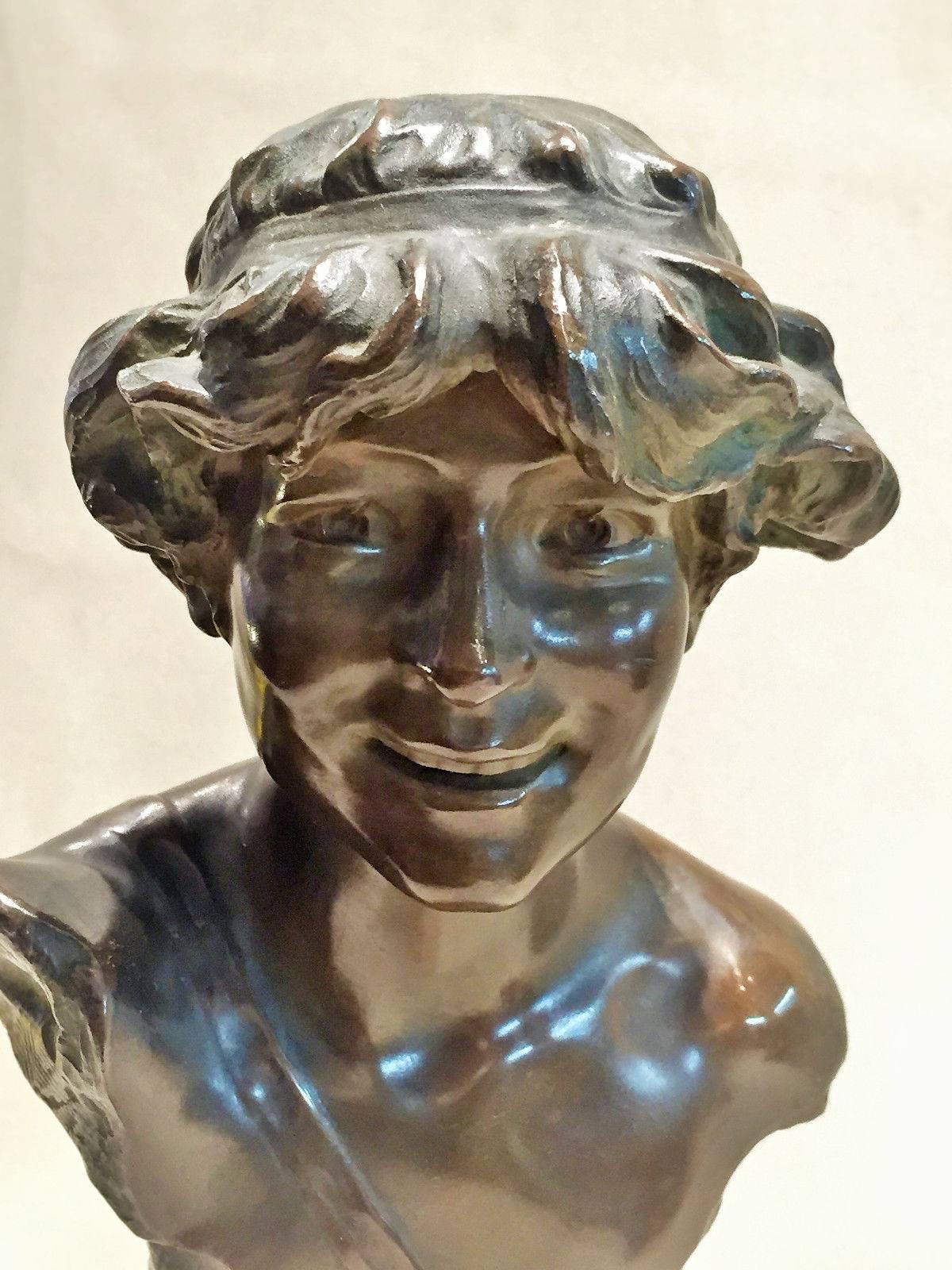 Made of a beautifully crafted dark-brown patinated bronze, this wonderful bust of a laughing girl proudly stands on its original marble base and bears artist's signature, A. Charroi, as well as unidentified diamond-shape foundry mark and bronze