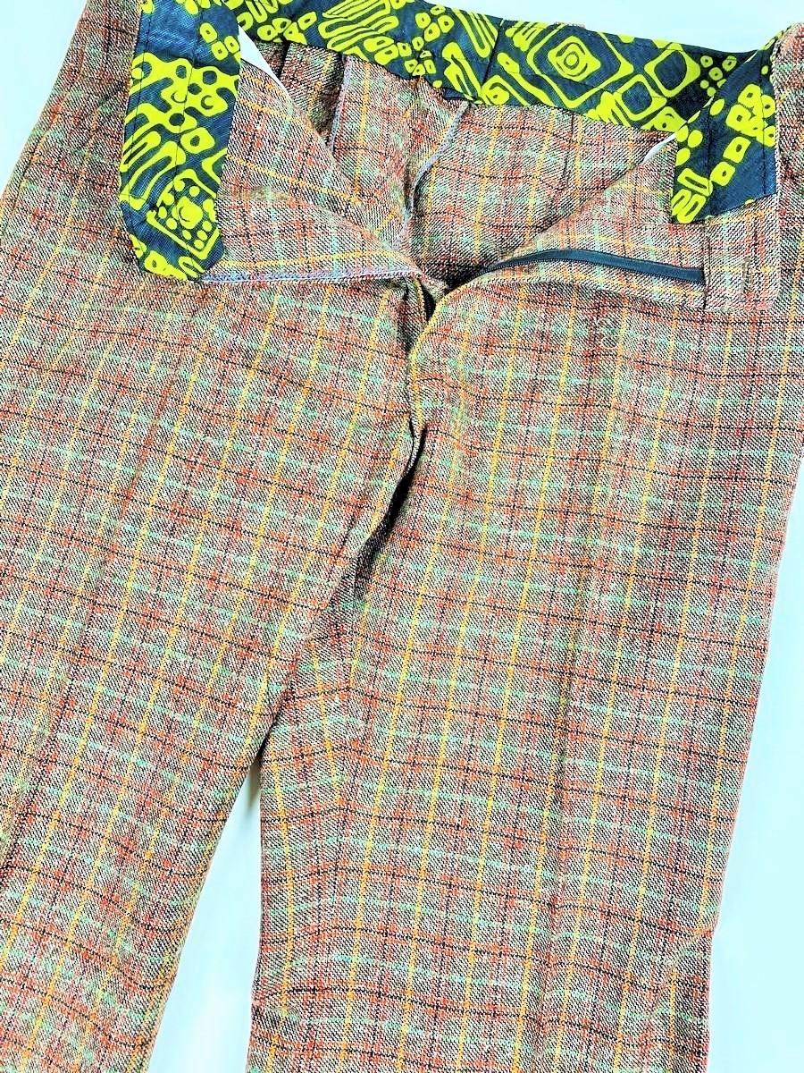 Circa 1972

France

A Large patte d'éléphant checked wool tweed trousers dating from the 1970s. High-waisted trousers, fly with plastic zip and closed at the front with a black plastic button. Wide belt loops and lining in green and brown nylon with