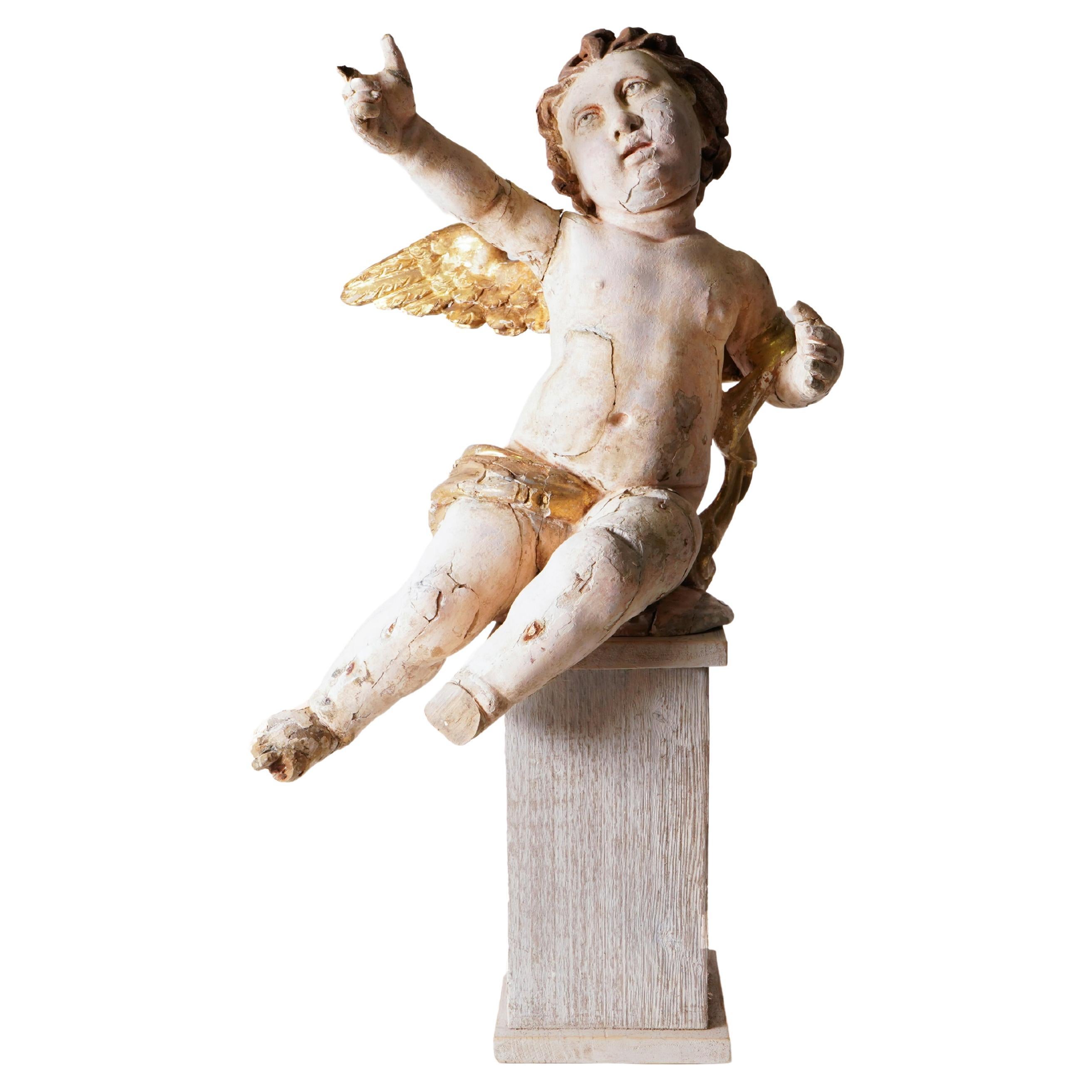 Cherub geschnitzt aus Holz mit polychromer und vergoldeter Vergoldung