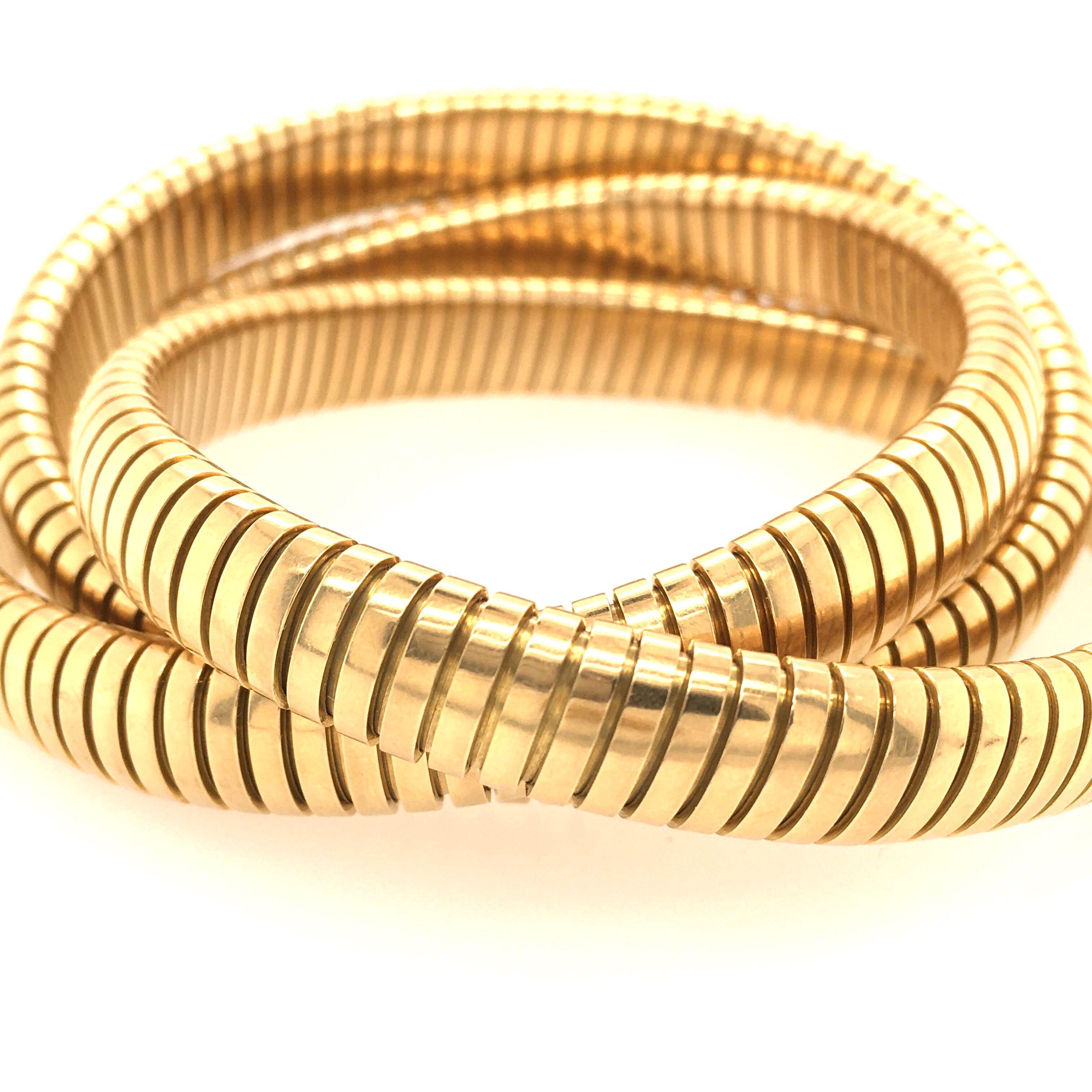 An 18 karat yellow gold bracelet. Italian. Designed as three (3) interlocking slightly flexible gaspipe  bracelets. Inside measurement is approximately 7 inches, gross weight is approximately 124.6 grams. 