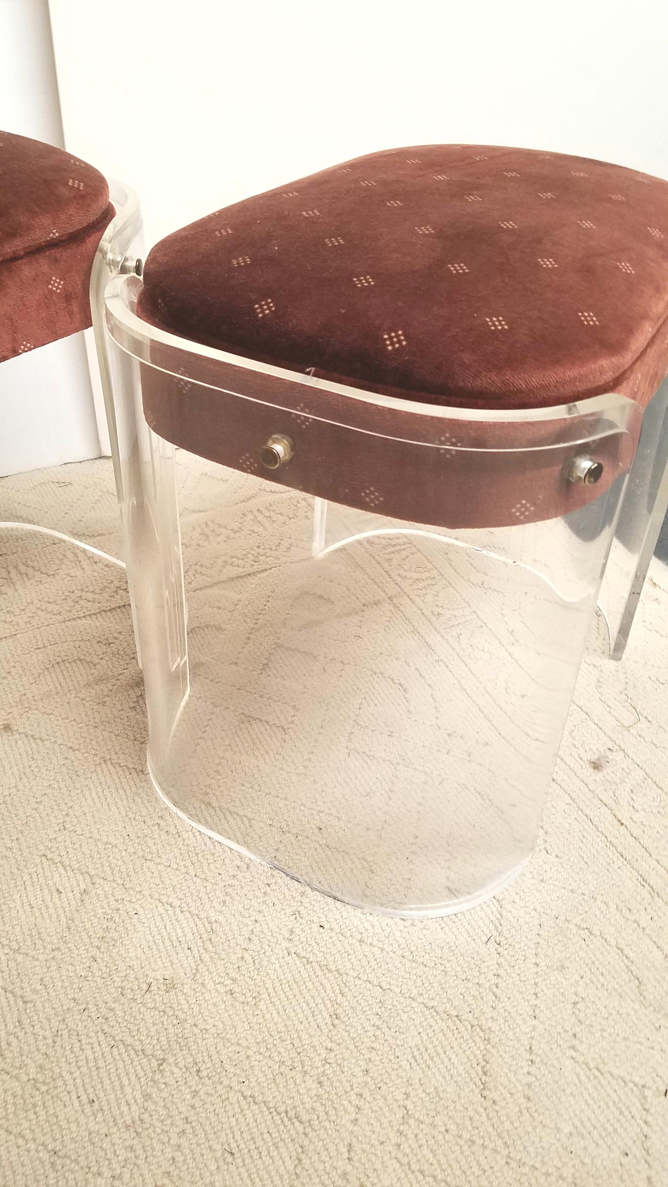 A chic pair of 1970s Lucite benches in original chocolate brown velvet in very good condition. The curved Lucite sides with an upholstered seat that could easily be recovered in a new fabric. Price is for the pair....