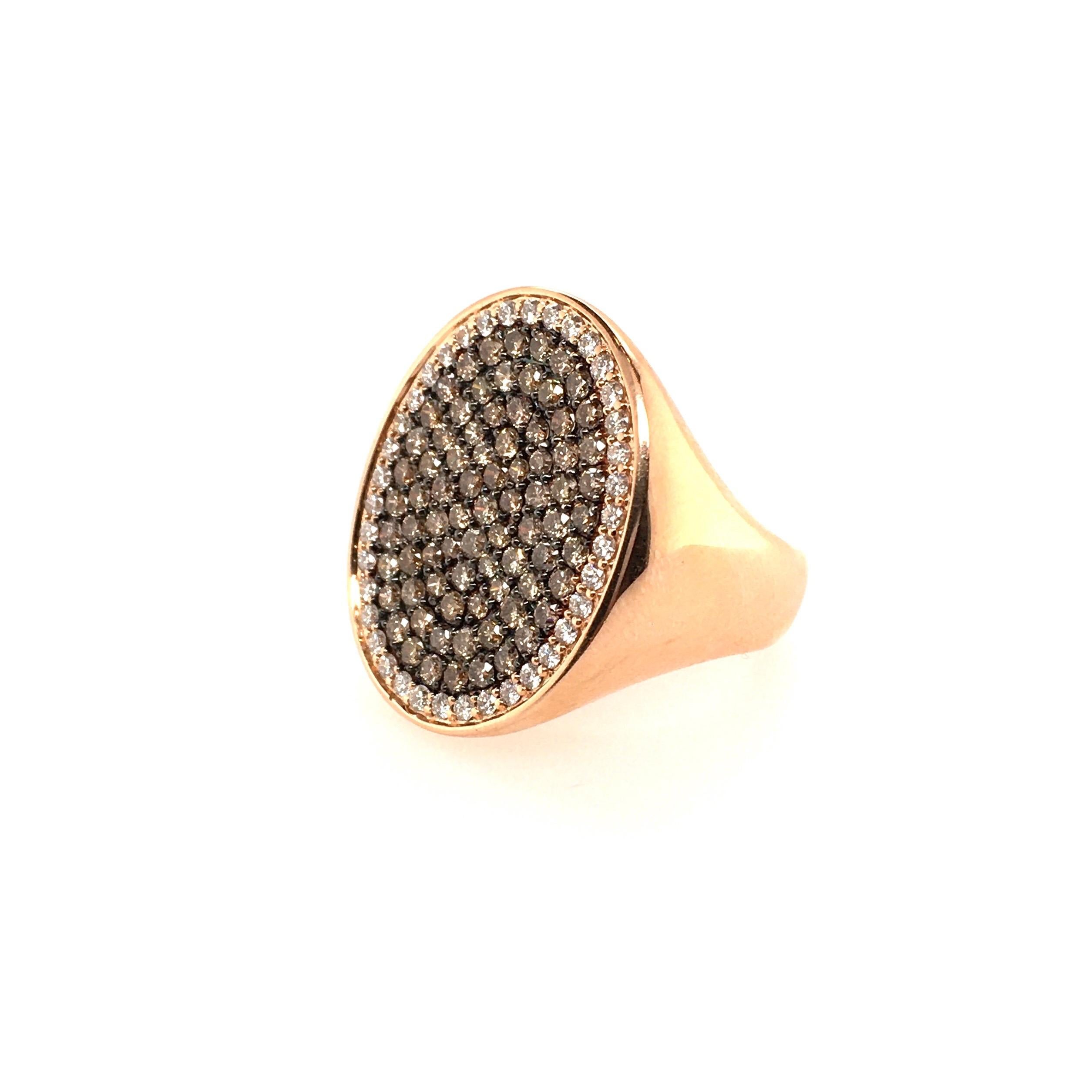 An 18 karat rose gold, brown diamond and diamond ring. Set with an oval pave set brown diamond and diamond plaque, within a polished gold mounting. Brown diamonds weigh 1.68 carats, colorless diamonds weigh 0.48 carats, total diamond weight is 2.16