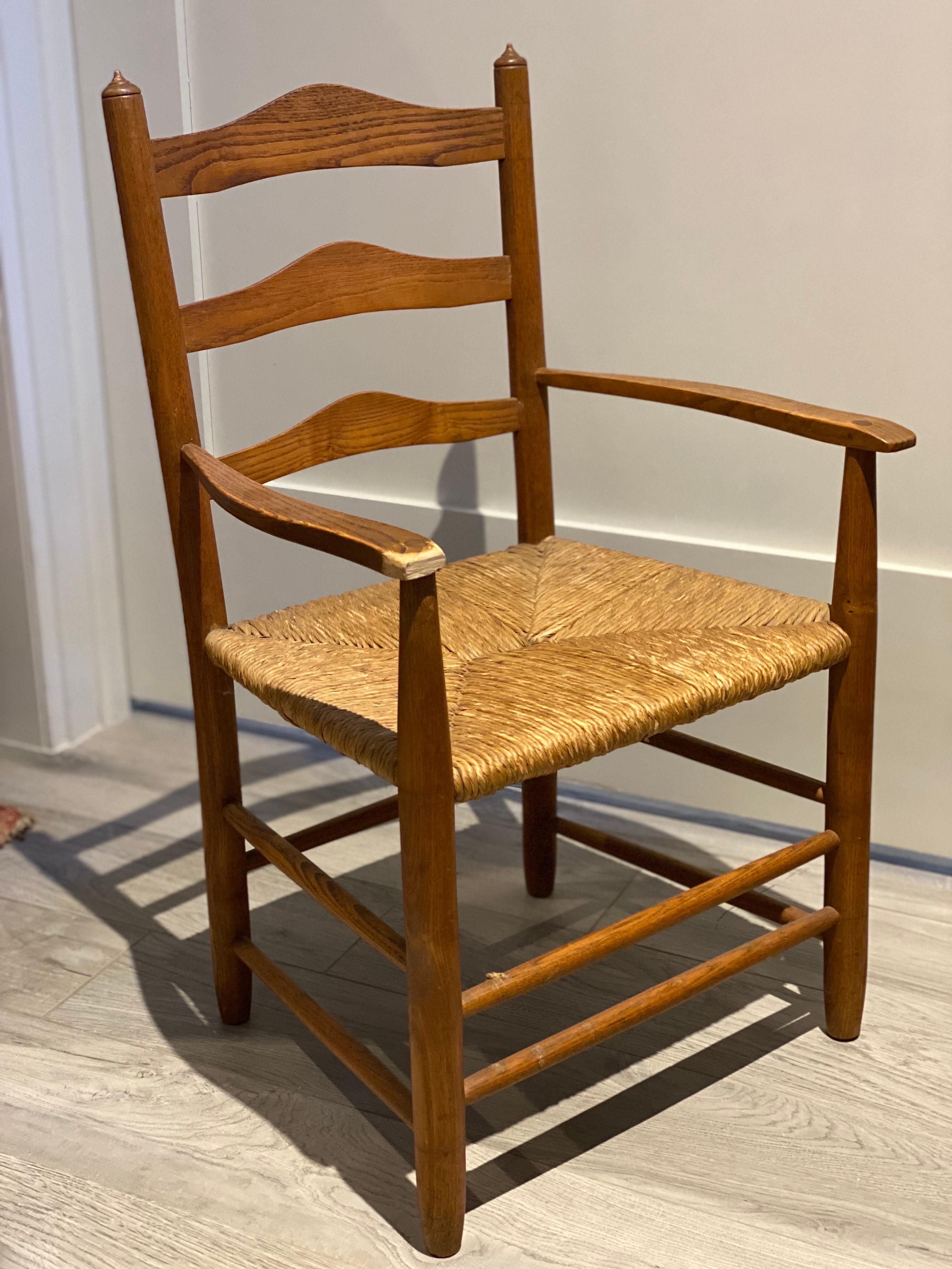 A Child's Wooden Chair with Handwoven Rush Seat, American, Late 20th Century.
Made of wood to fit a small child, probably a toddler to young elementary school age. Finely crafted wood frame with handwoven rush seat. End of right arm has been cut