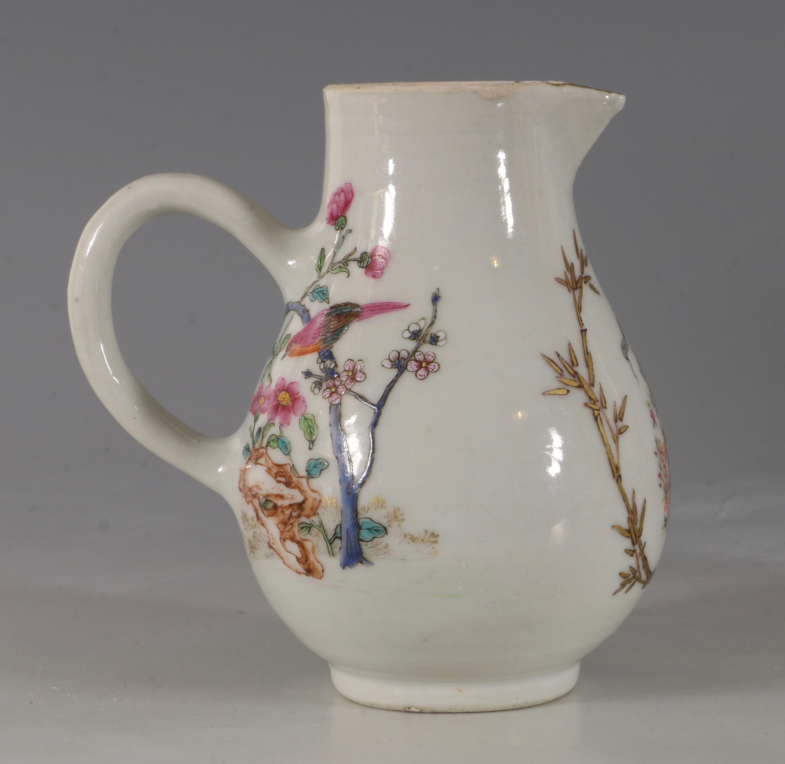 An armorial cream jug with a finely drawn coat of arms within bamboo sprays below the motto 'Omnia Vincit Labor' (Work conquers all).

The reverse attractively decorated with two birds, one perched on prunus the other on a rock.

The decoration