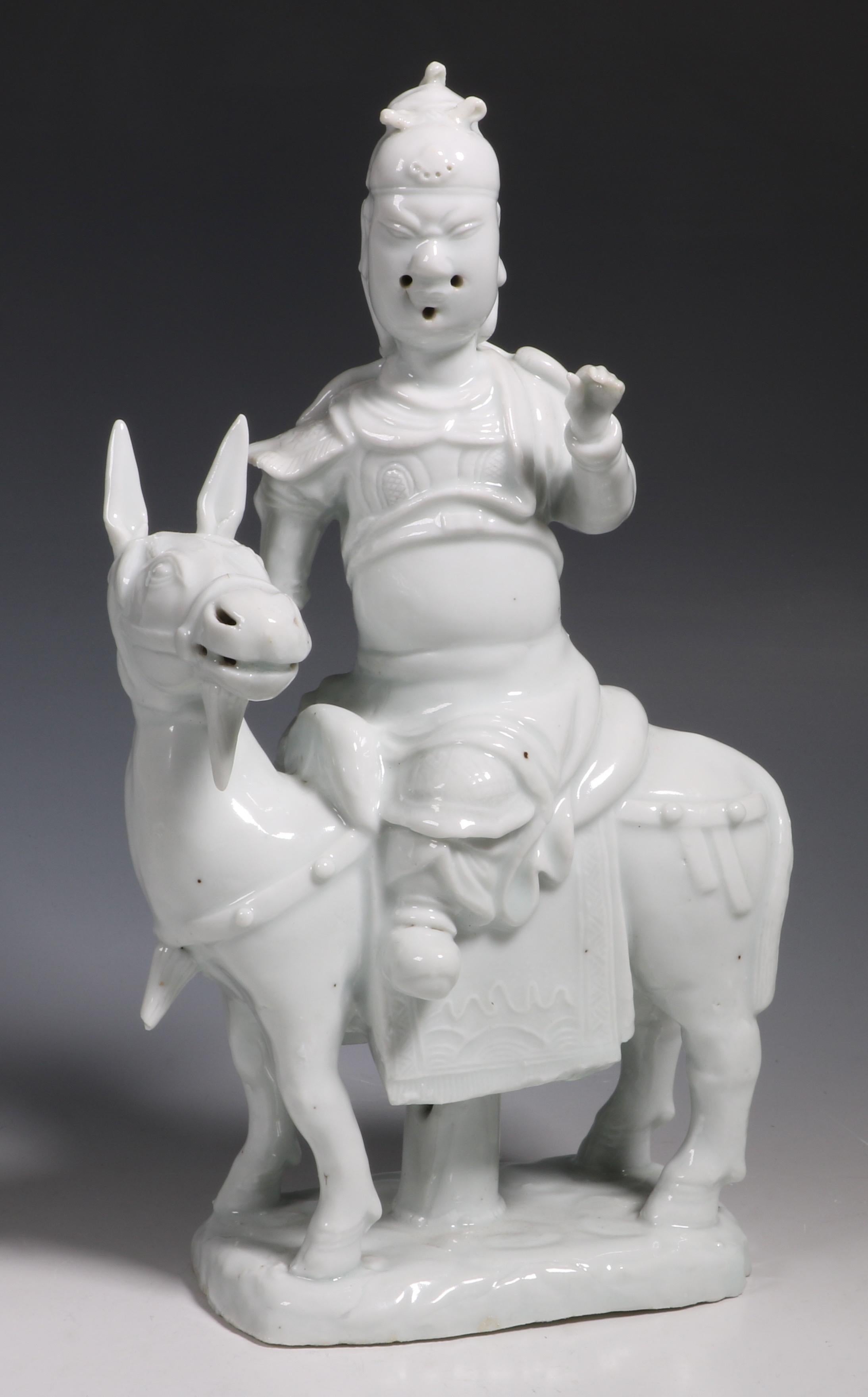 A Blanc de Chine figure of Guandi. The well modelled Deity seated on his mount Red Rabbit who is standing on a base of clouds.
Kangxi, late 17th century.