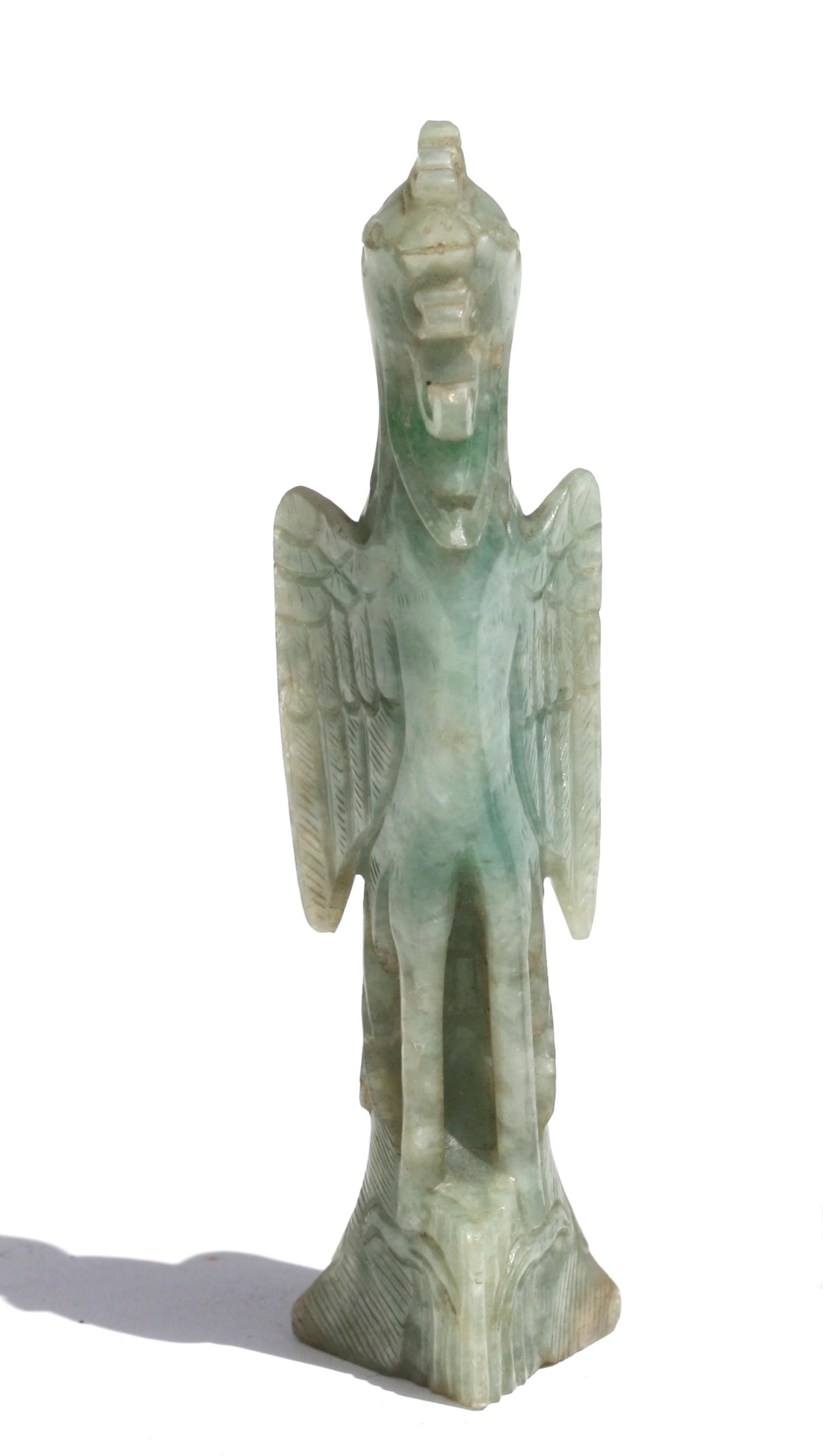 A Chinese carved jade figure of a phoenix
Third quarter 20th century
Perching atop rockwork with the finely incised wings
Measures: height 5 in. (12.7 cm.) 
Provenance:
A Palm Beach Gentleman.